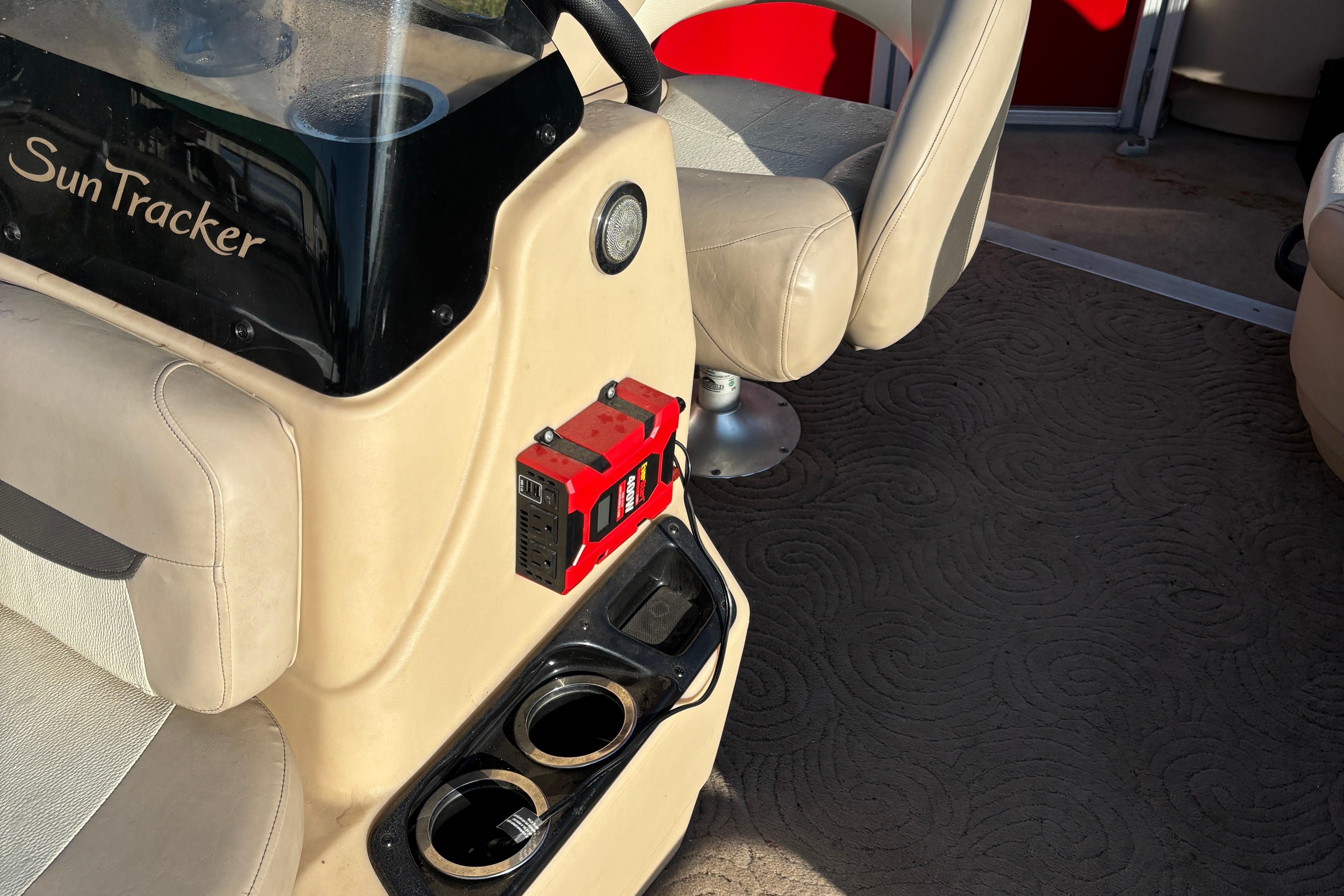 Interior of 2014 Sun Tracker Bass Buggy 18 DLX with beige seating and cup holders.