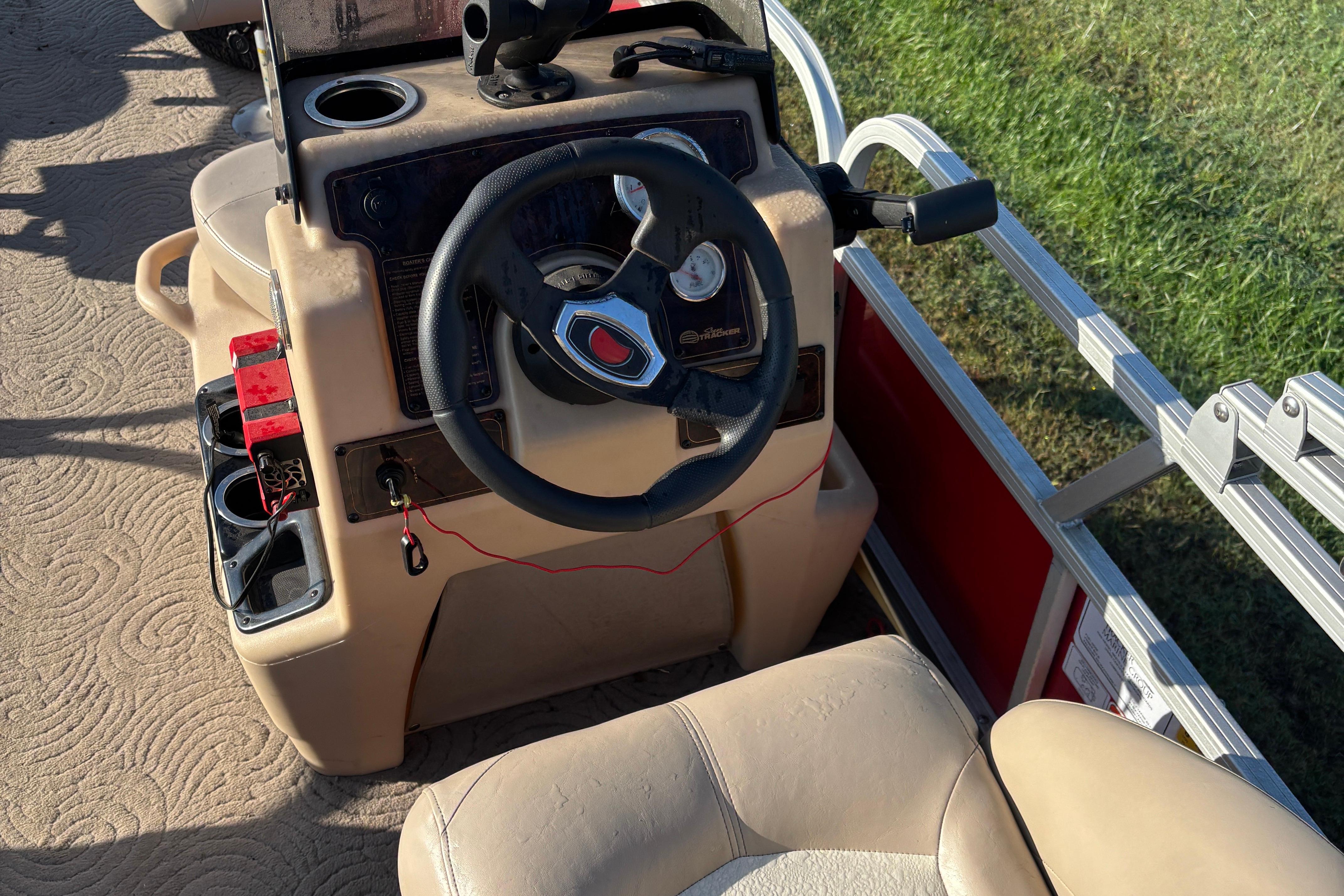 2014 Sun Tracker Bass Buggy 18 DLX steering console with cup holders and seating.