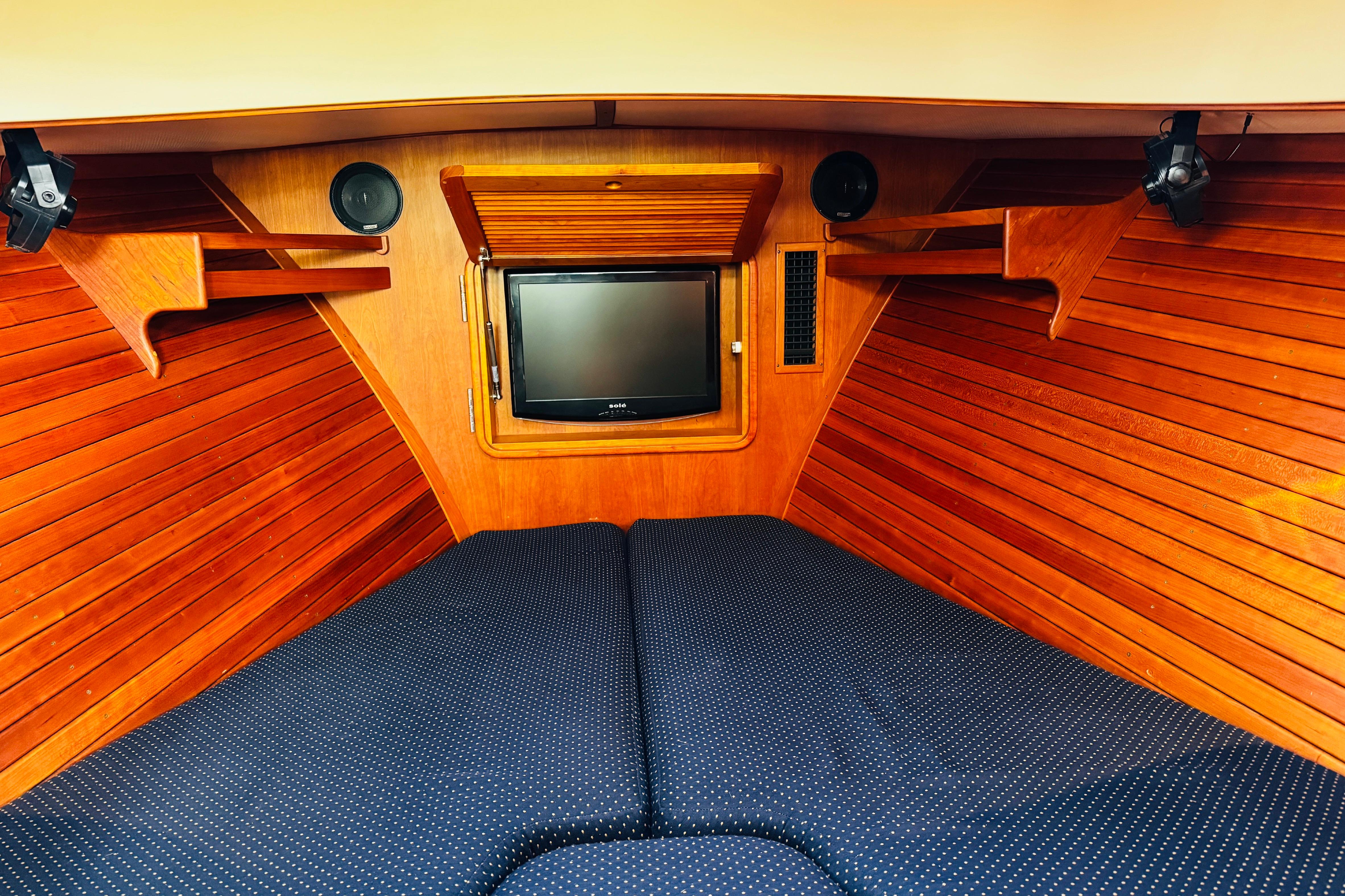 Interior of 2012 Hinckley Picnic Boat MKIII with wood paneling and TV.
