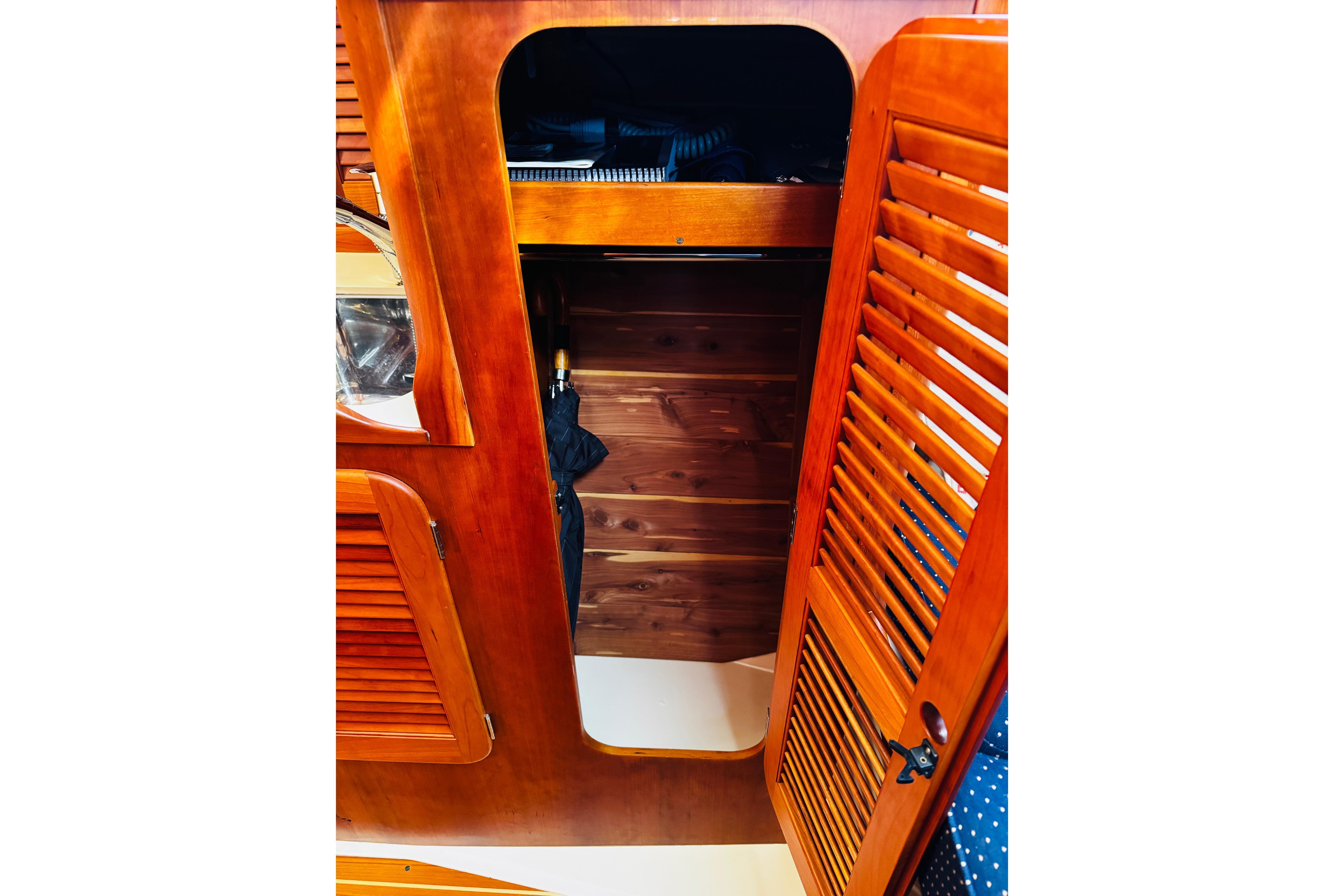 Interior of 2012 Hinckley Picnic Boat MKIII with wooden cabinetry and louvered doors.