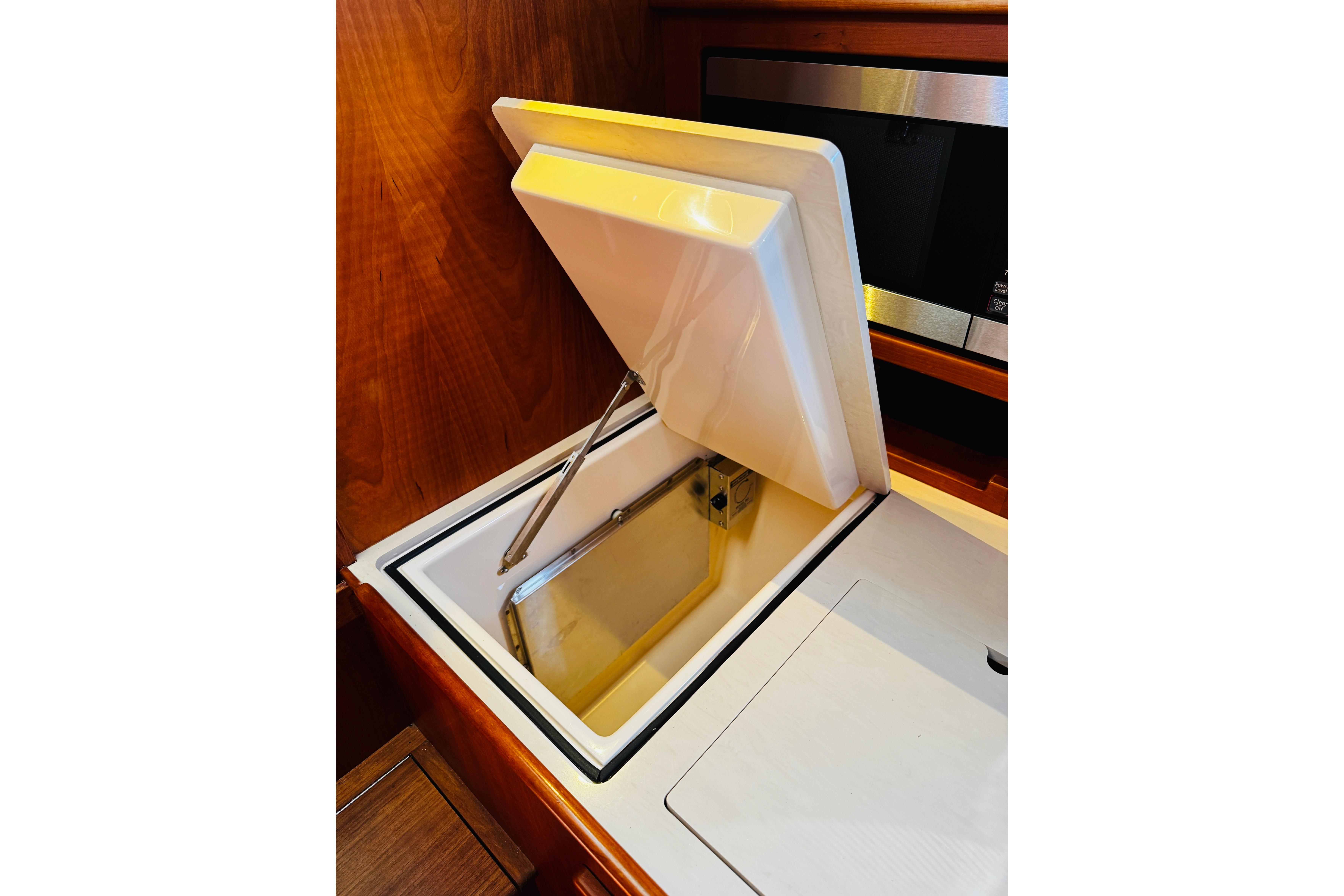 Hinckley Picnic Boat MKIII 2012 interior with open storage compartment.