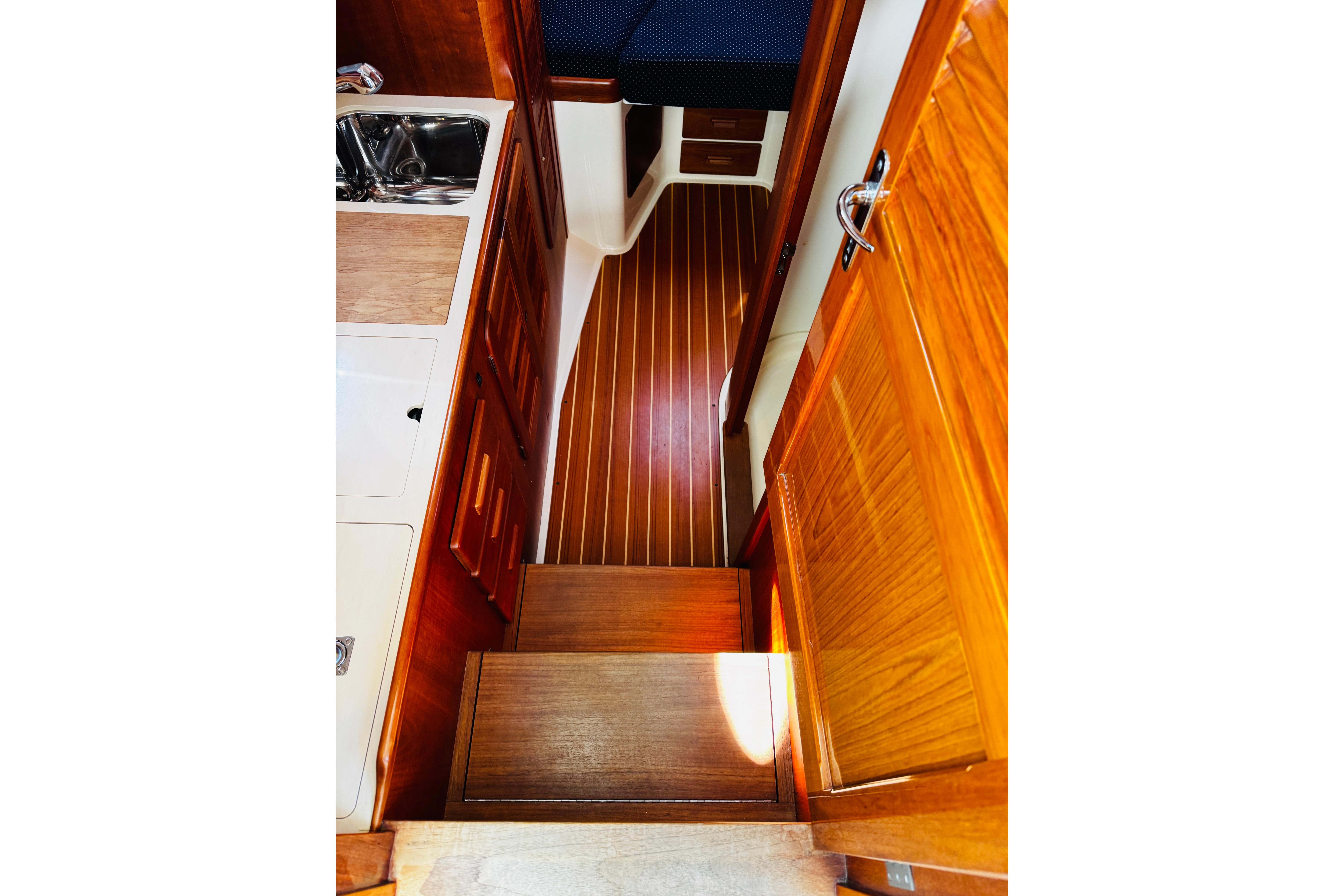 Interior of 2012 Hinckley Picnic Boat MKIII with wooden cabinetry and flooring.