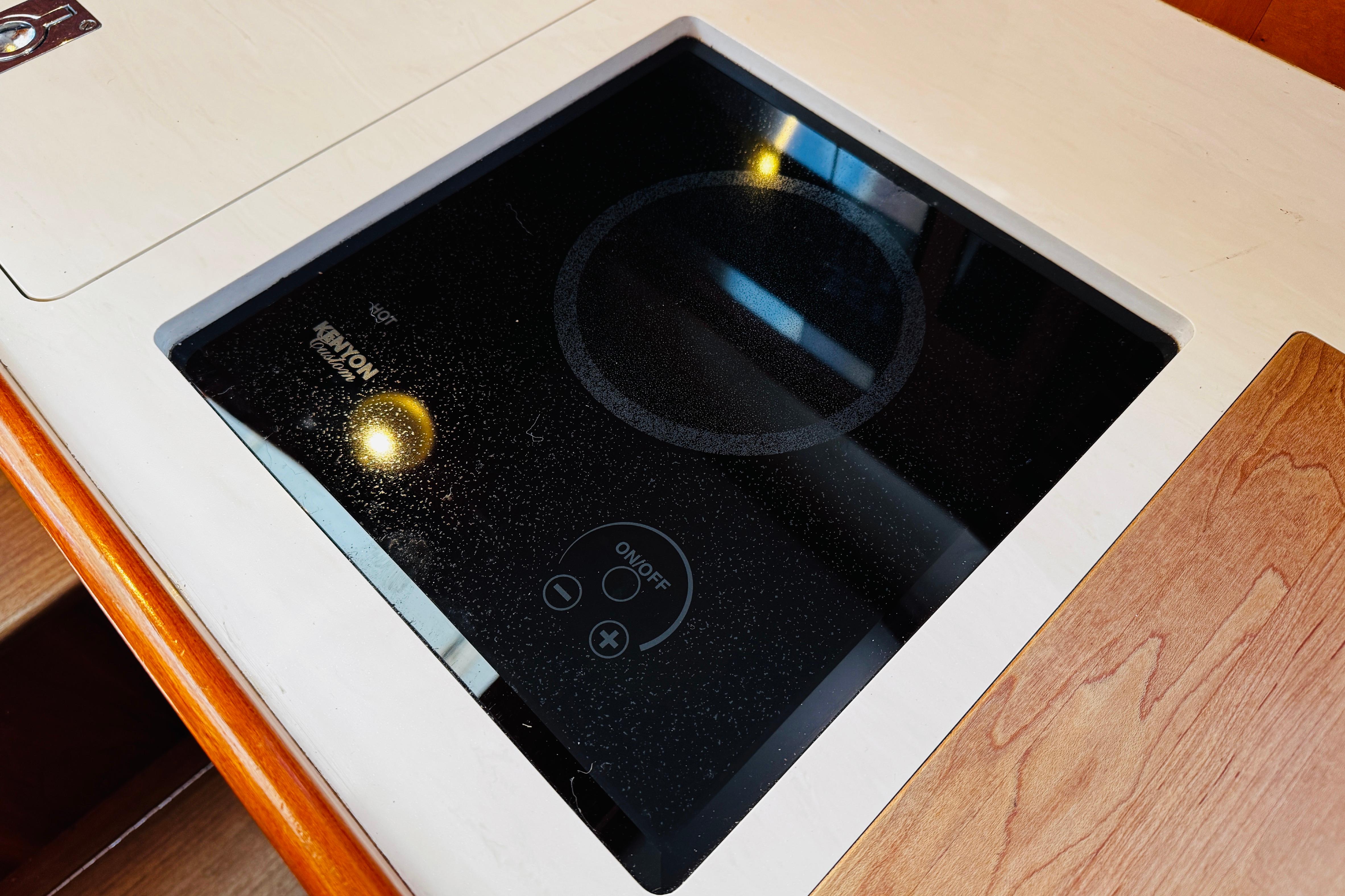 Hinckley Picnic Boat MKIII 2012 features a sleek Kenyon electric cooktop in the galley.