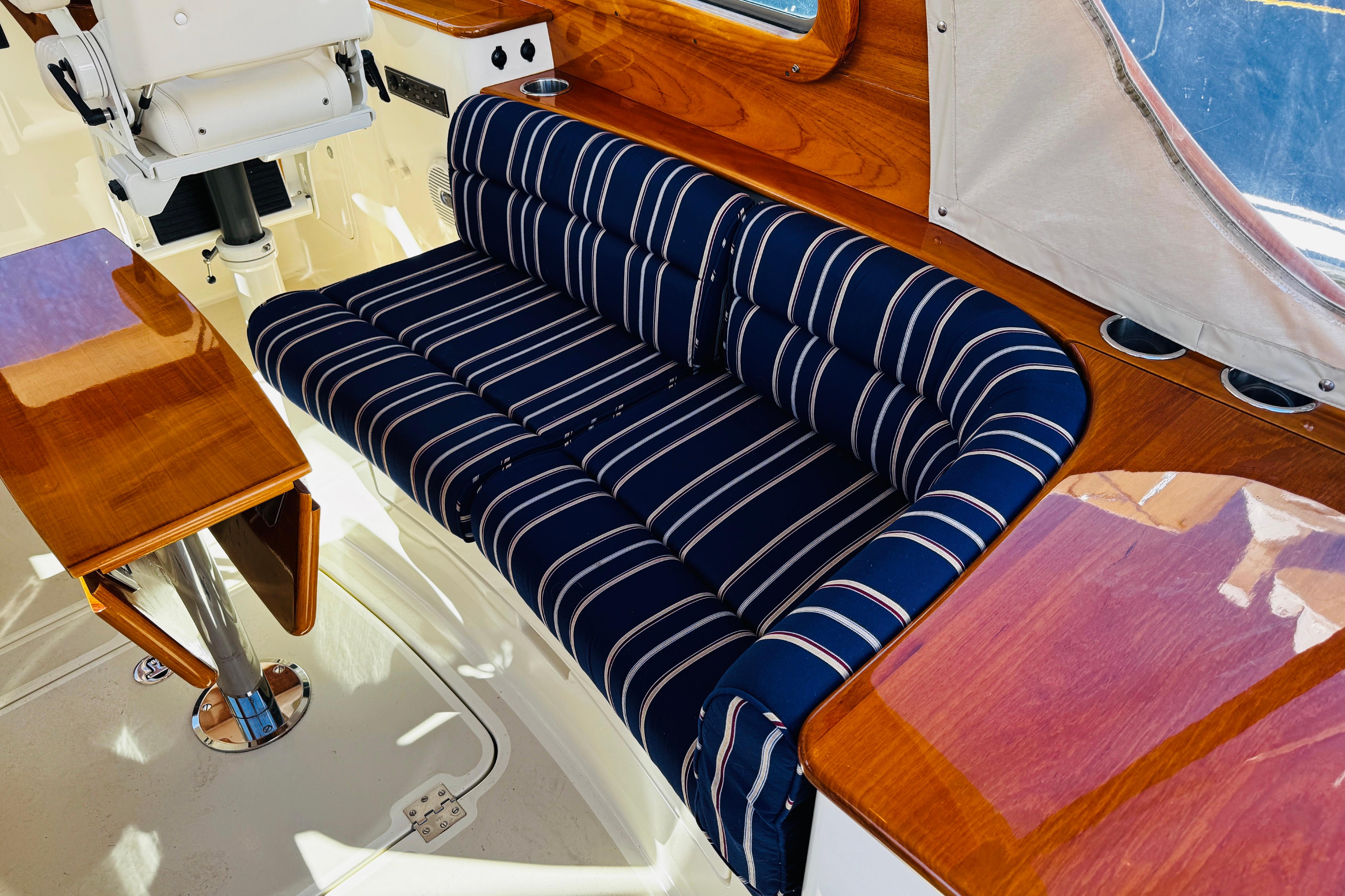 2012 Hinckley Picnic Boat MKIII interior with striped seating and polished wood finish.