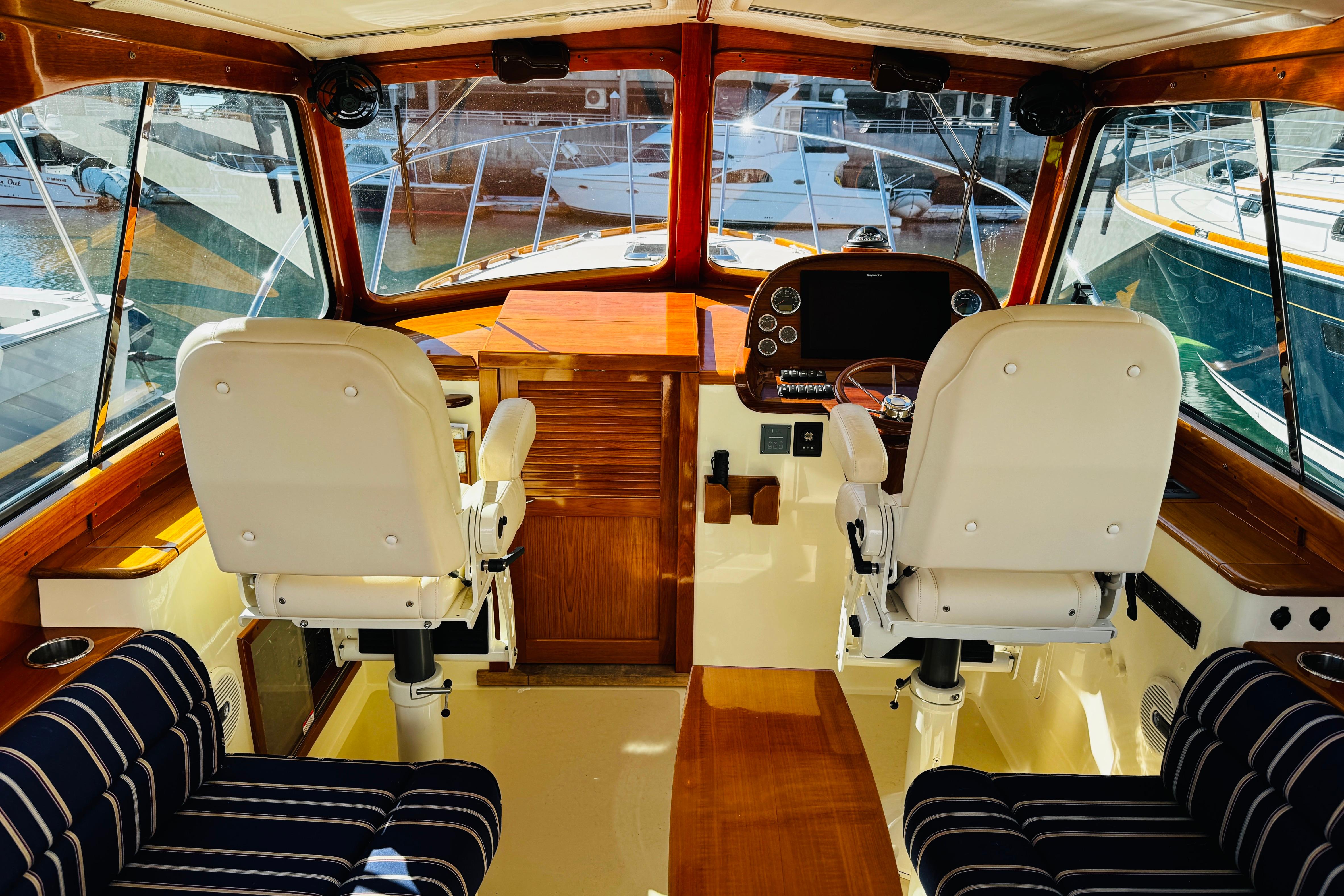 Interior of 2012 Hinckley Picnic Boat MKIII with helm and seating area.