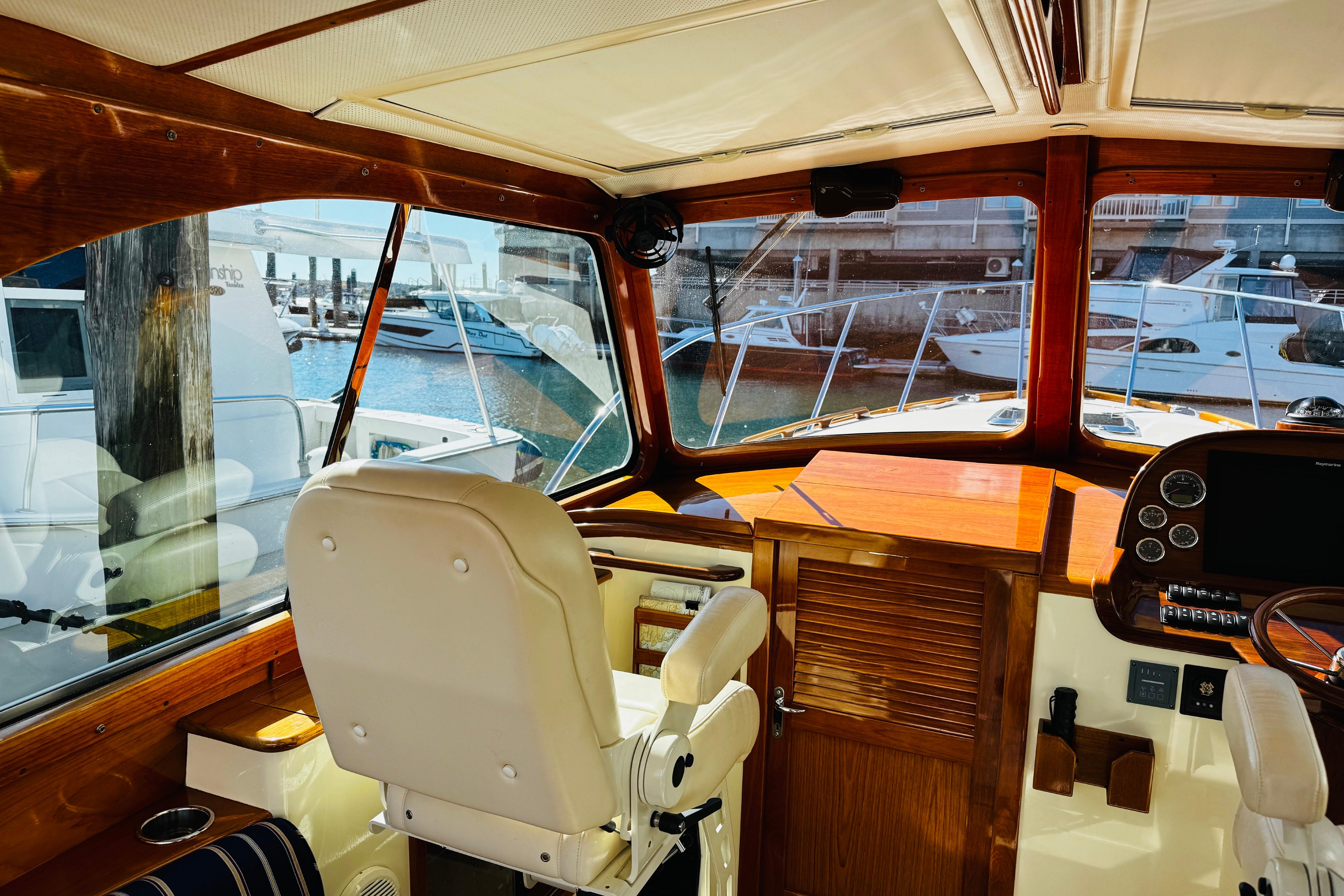 Interior of 2012 Hinckley Picnic Boat MKIII with helm and marina view.