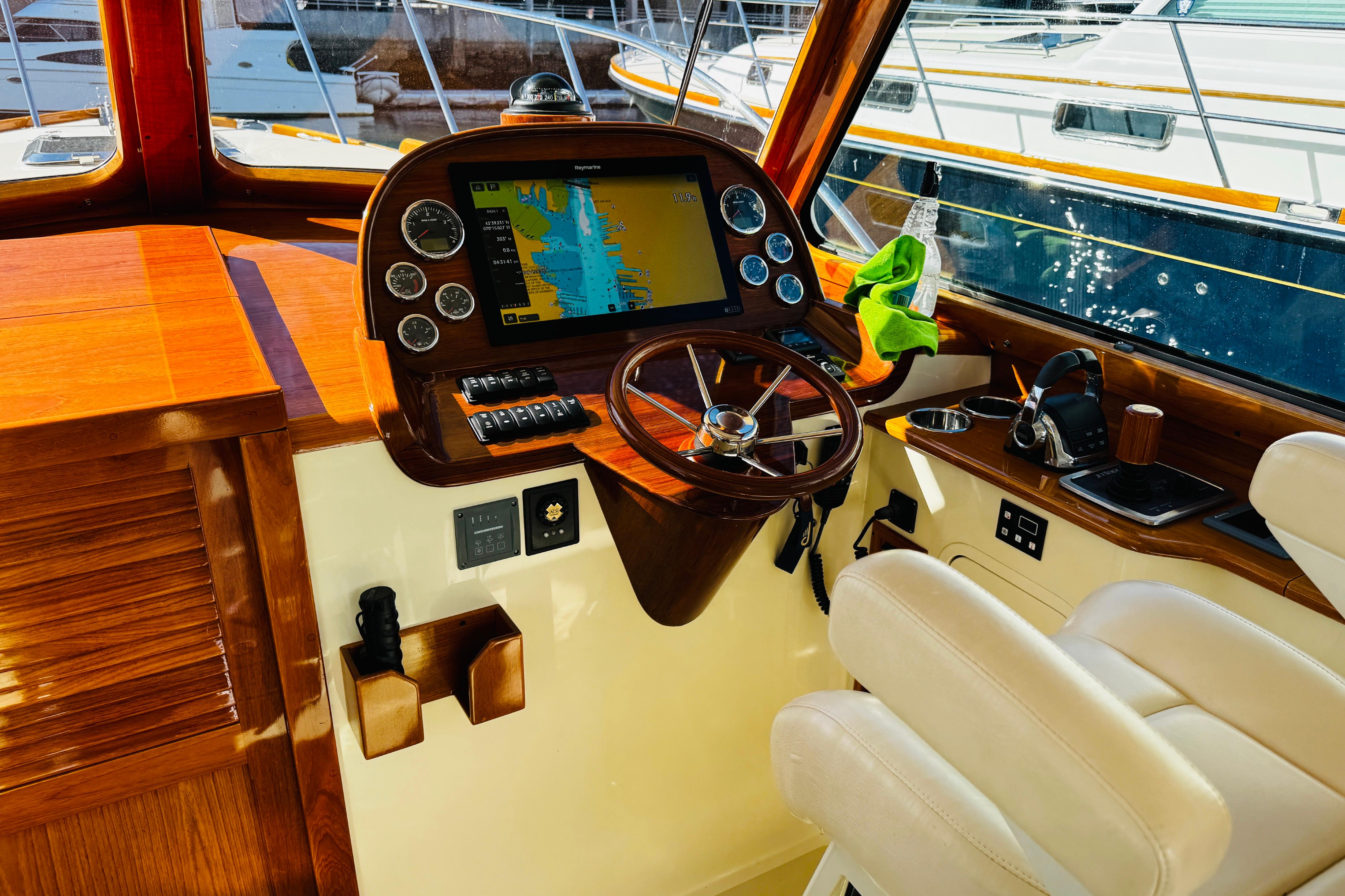 Interior of 2012 Hinckley Picnic Boat MKIII with wooden dashboard and navigation system.