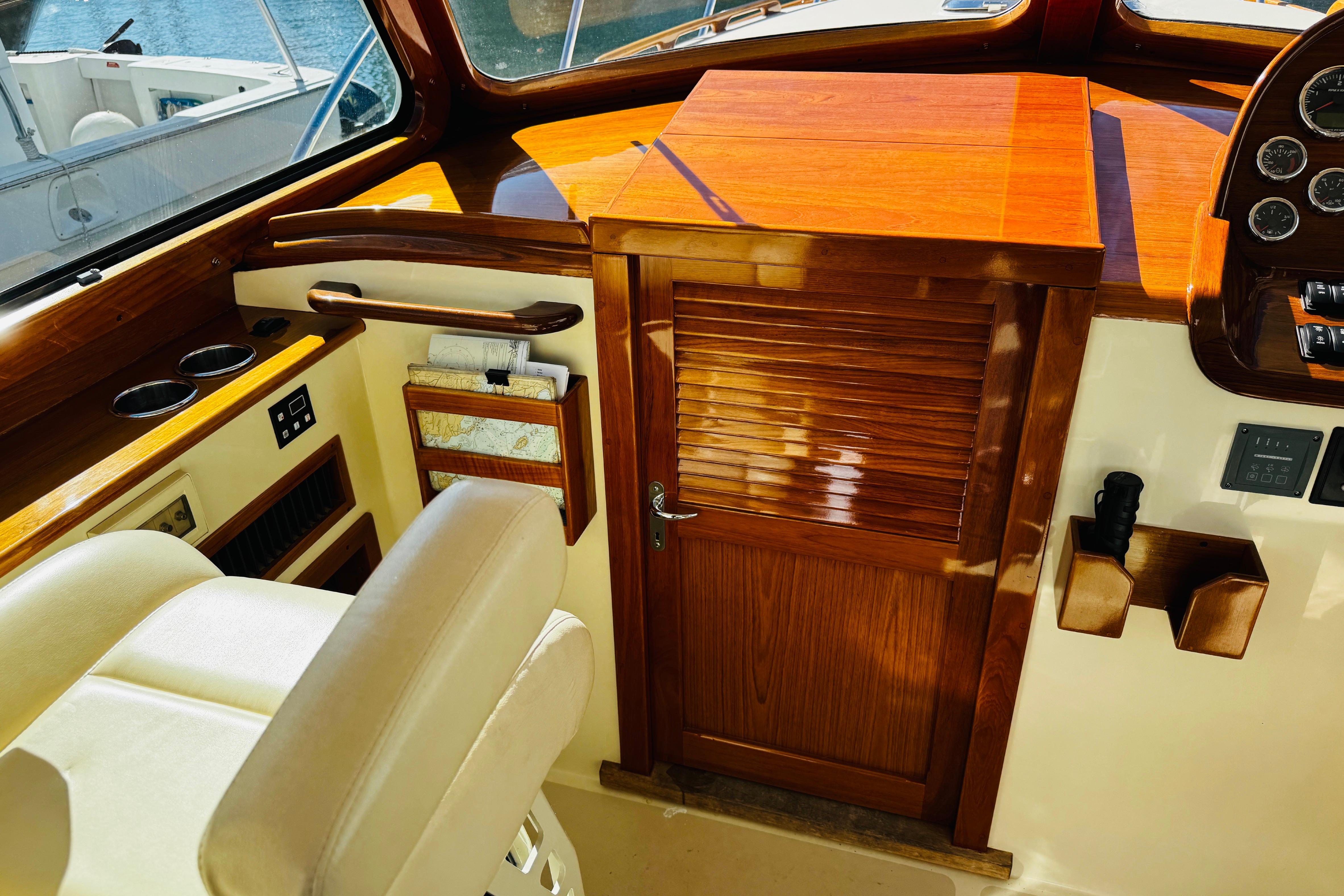 Interior of 2012 Hinckley Picnic Boat MKIII with polished wood and leather seating.