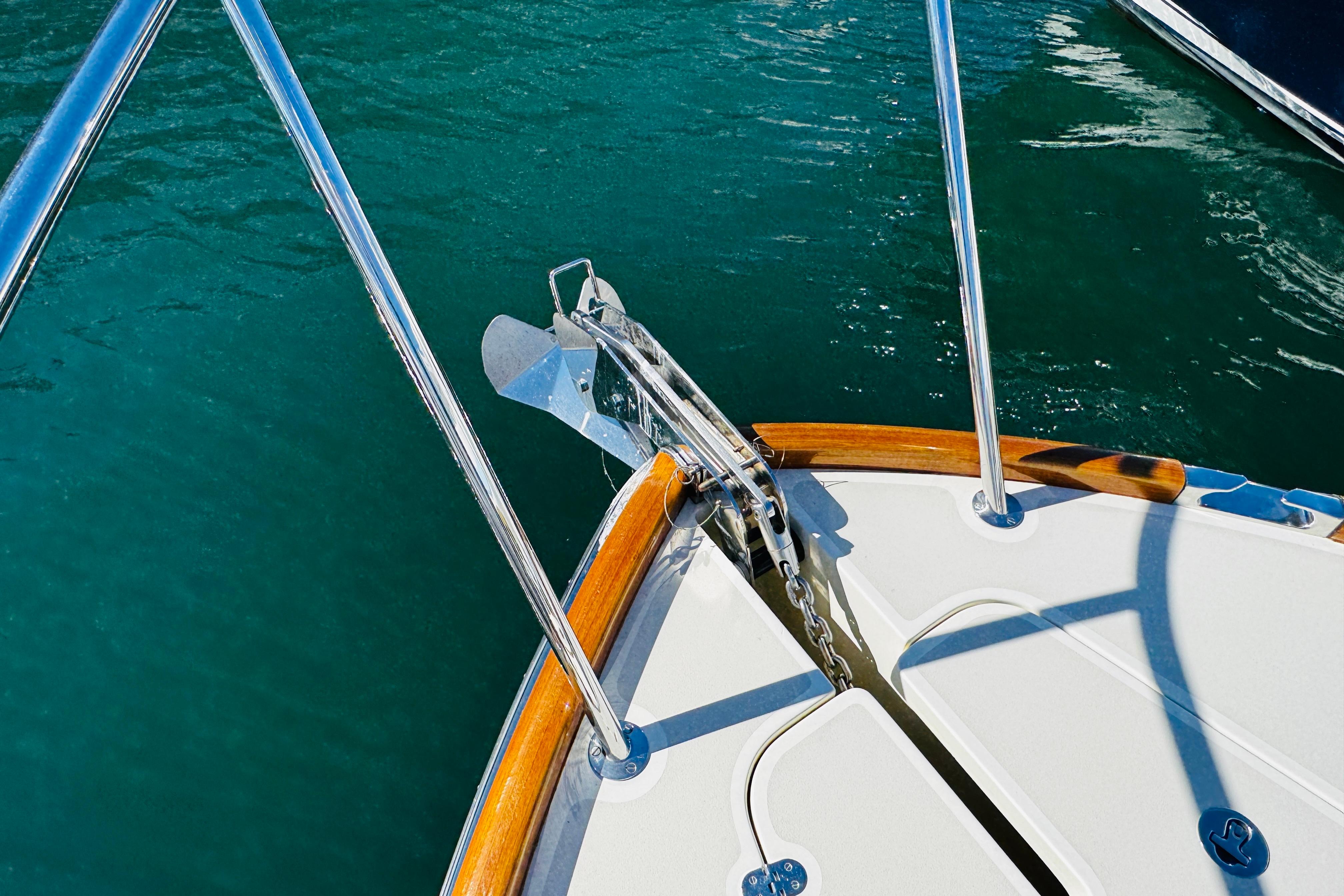Bow of 2012 Hinckley Picnic Boat MKIII with anchor and teak accents.