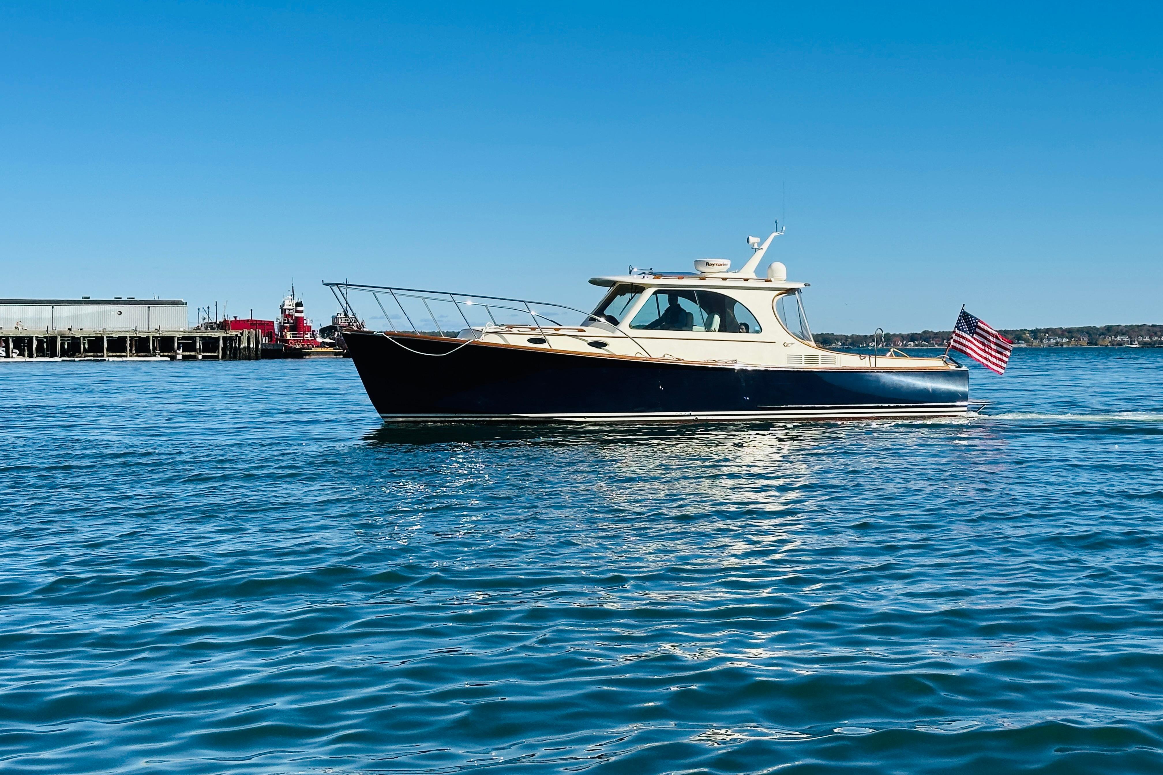 2012 Hinckley Picnic Boat MKIII cruising on calm blue waters under clear sky.