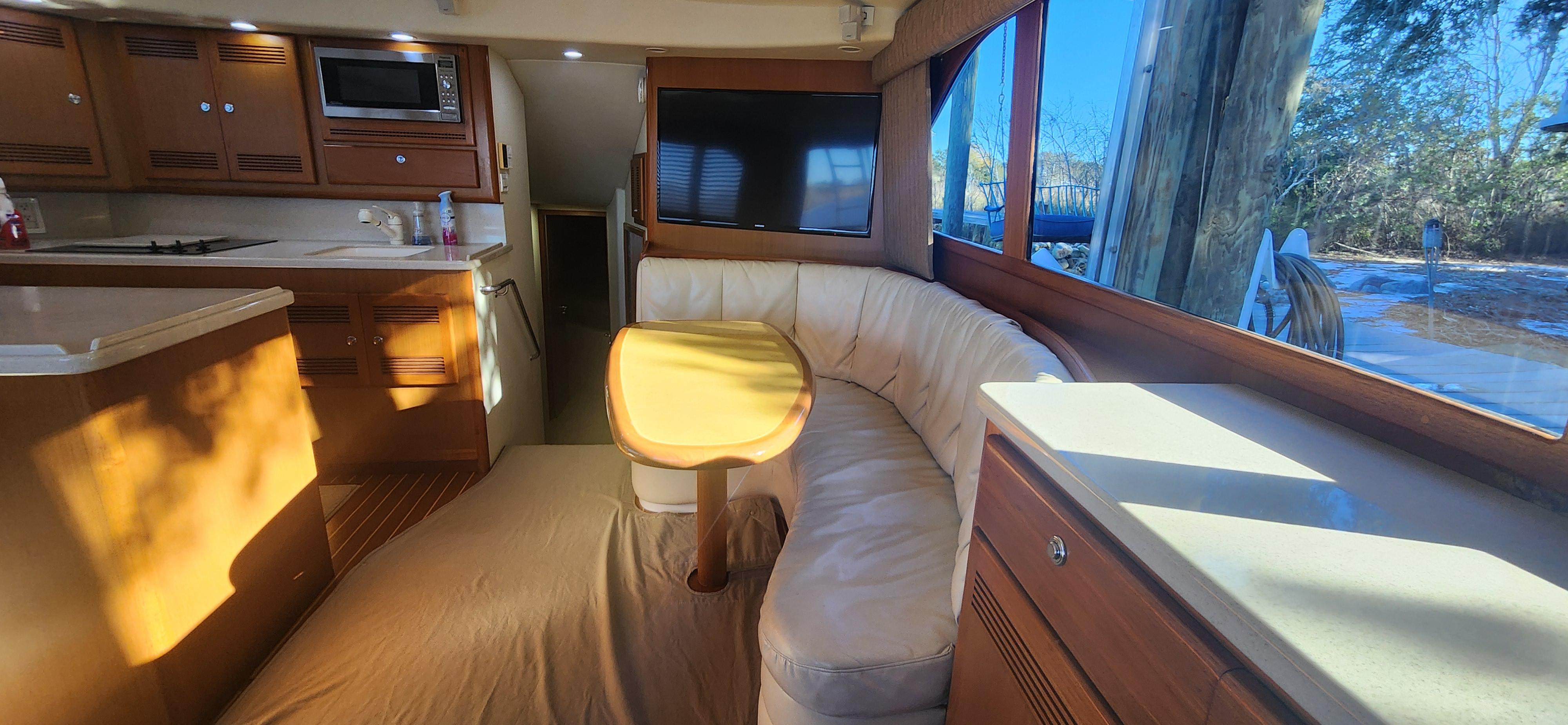Cabo-48 Convertible 2004-Laura K AL-US-Interior of 2004 Cabo 48 Convertible yacht with kitchen and seating area.-9710440 | Thumbnail