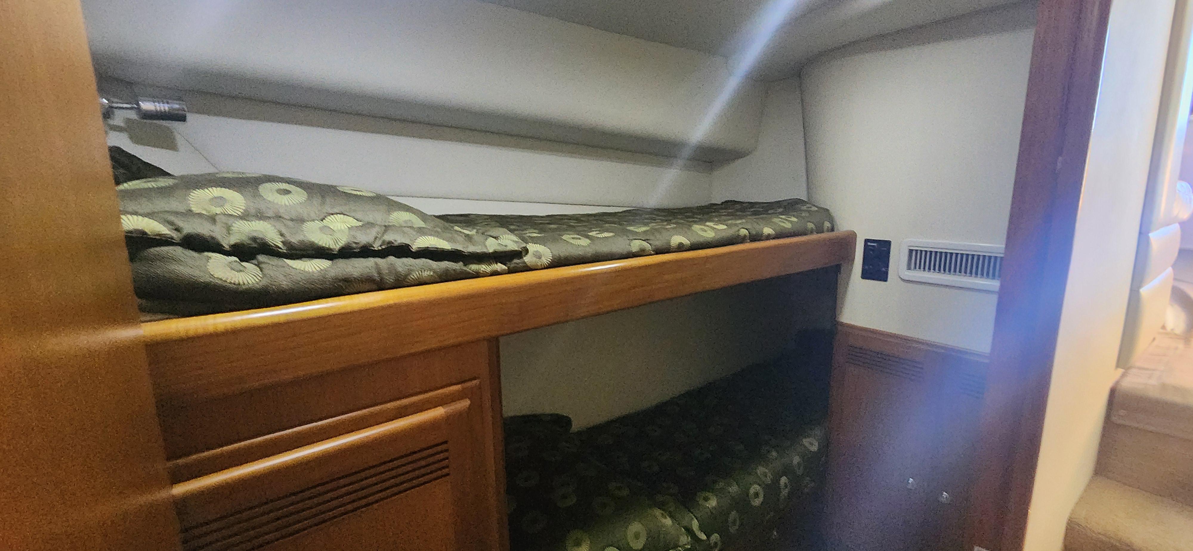 Cabo-48 Convertible 2004-Laura K AL-US-2004 Cabo 48 Convertible yacht interior with cozy bunk beds and wooden cabinetry.-9710440 | Thumbnail