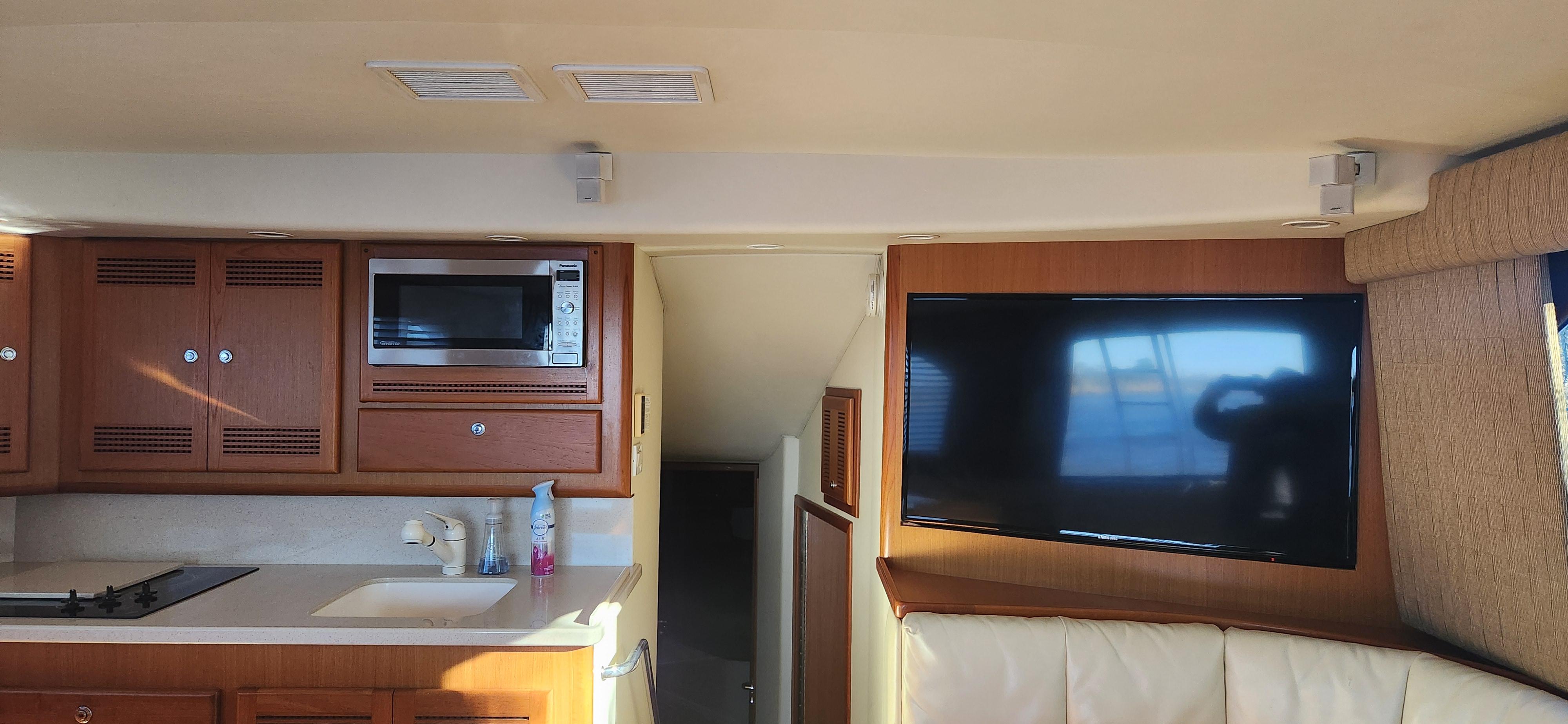 Cabo-48 Convertible 2004-Laura K AL-US-Interior of 2004 Cabo 48 Convertible yacht with kitchen and TV area.-9710440 | Thumbnail