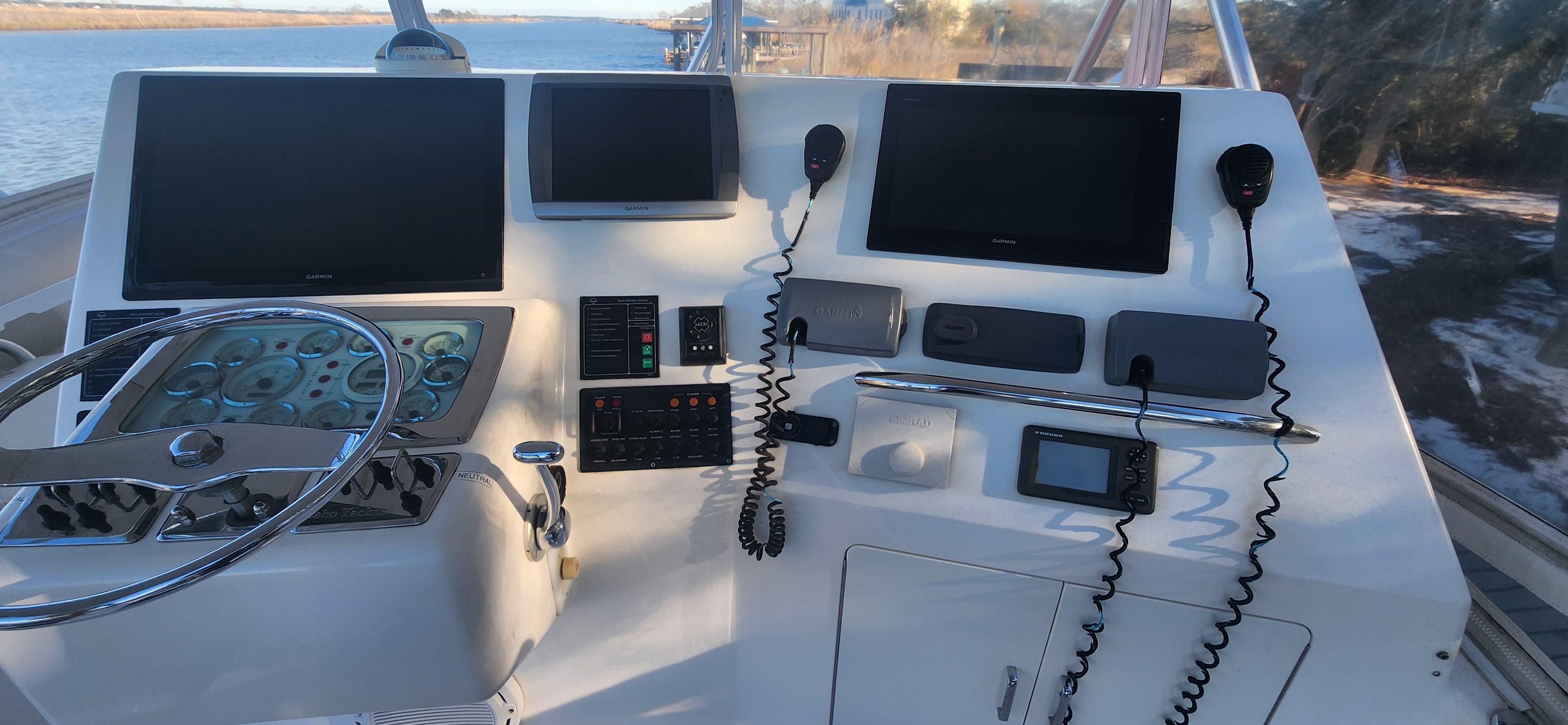 Cabo-48 Convertible 2004-Laura K AL-US-Helm of 2004 Cabo 48 Convertible yacht with navigation screens and controls.-9710440 | Thumbnail