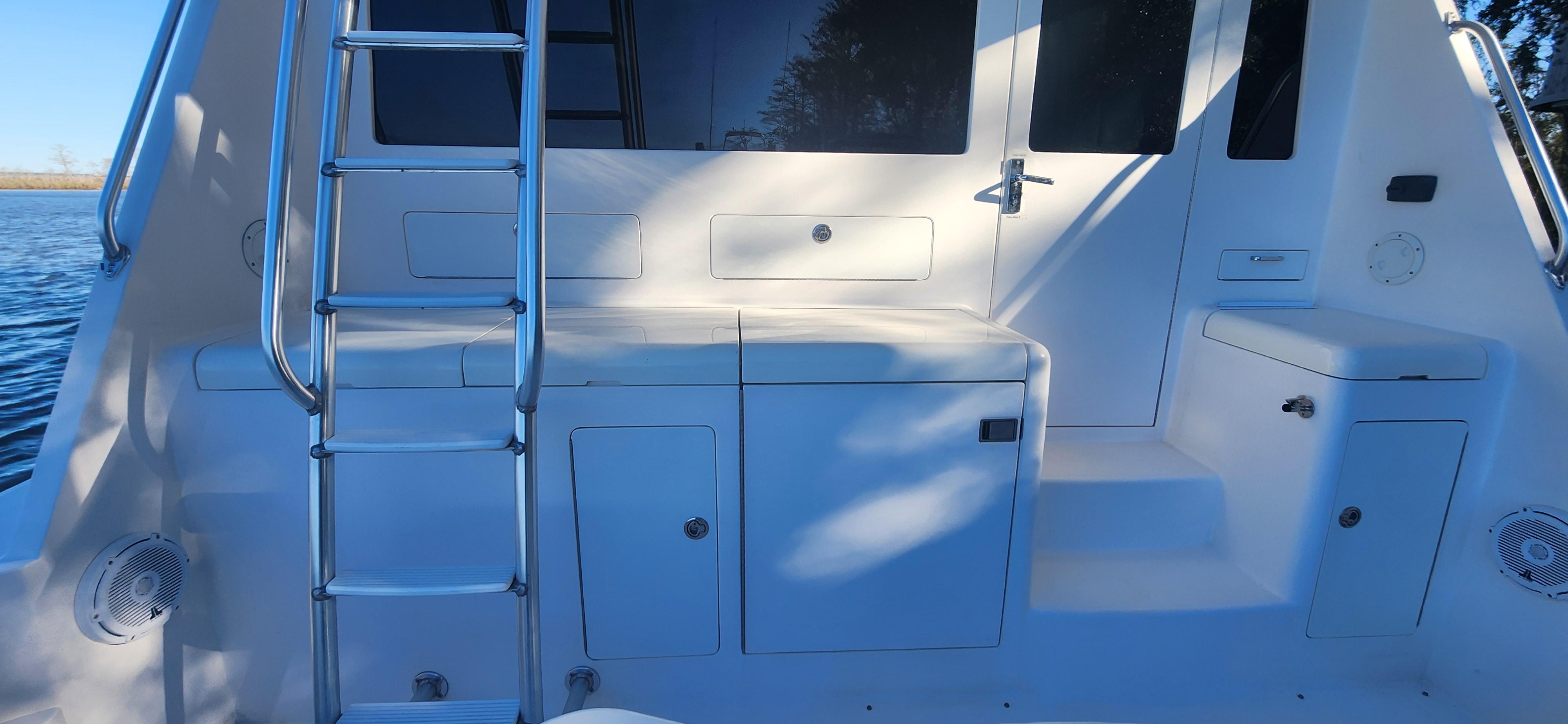Cabo-48 Convertible 2004-Laura K AL-US-2004 Cabo 48 Convertible yacht deck with ladder and storage compartments.-9710440 | Thumbnail