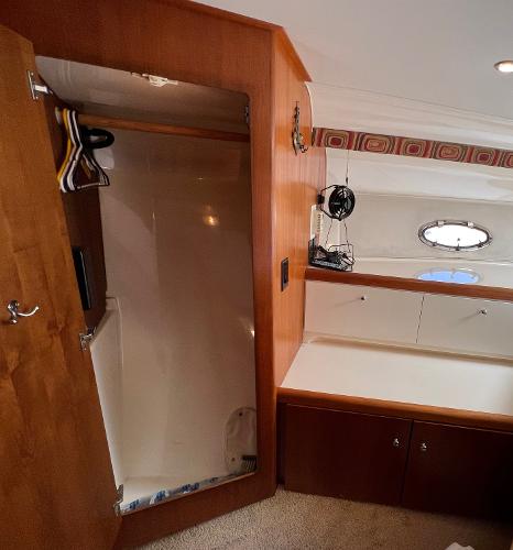1997 Carver 350 Mariner interior with wooden closet and porthole window.