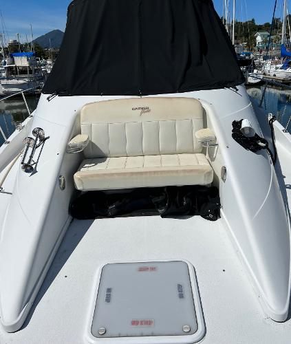 1997 Carver 350 Mariner boat with cushioned seating, docked in a marina.