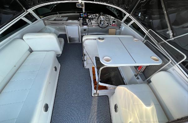1997 Carver 350 Mariner interior with seating, table, and helm station.