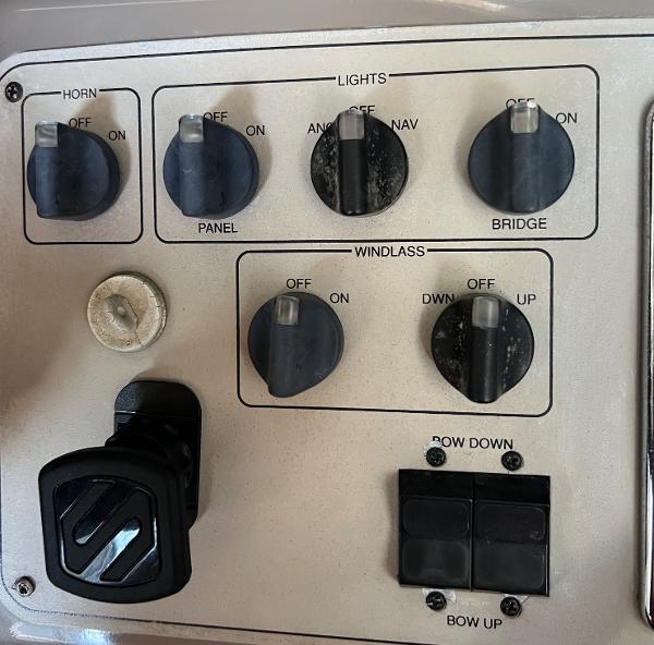 Control panel of a 1997 Carver 350 Mariner boat with various switches and knobs.