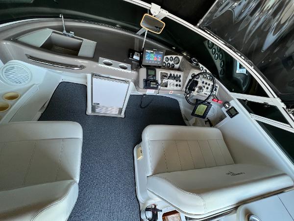 1997 Carver 350 Mariner cockpit with dual seats, control panel, and navigation equipment.