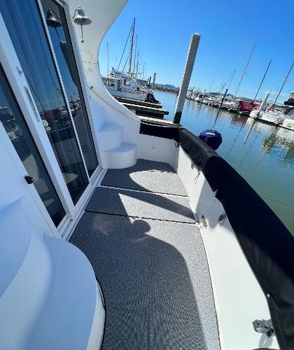 1997 Carver 350 Mariner yacht docked, featuring spacious deck and marina view.