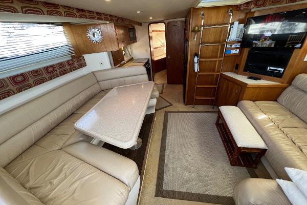 Interior of 1997 Carver 350 Mariner yacht with beige seating and wooden accents.