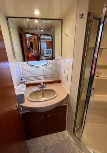 Bathroom interior of a 1997 Carver 350 Mariner yacht with sink and shower.
