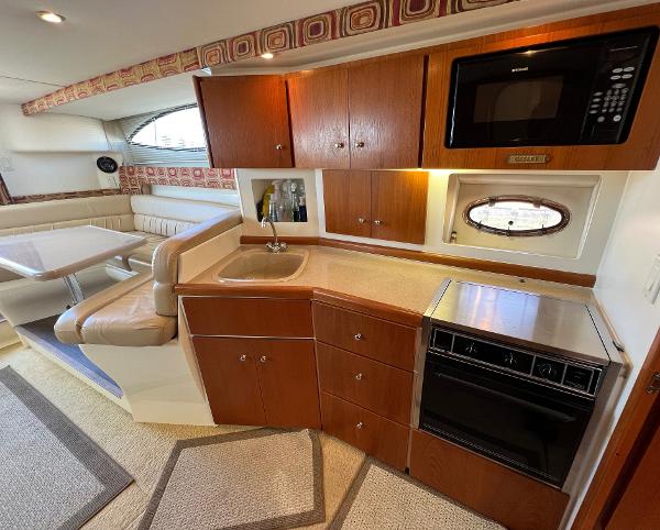 Interior of 1997 Carver 350 Mariner yacht with kitchen and dining area.