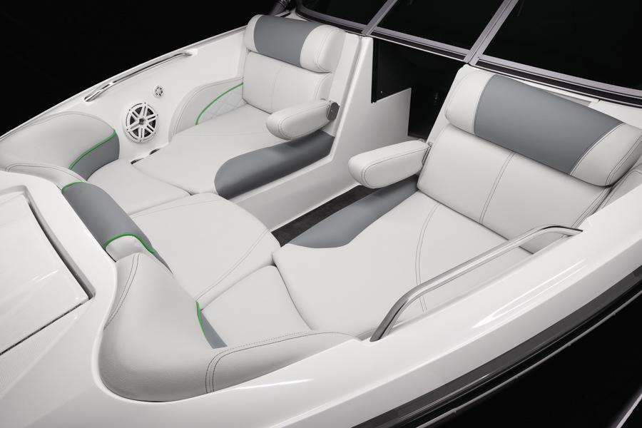 2013 MasterCraft X-25 boat interior with white and gray seating, featuring armrests and speaker.
