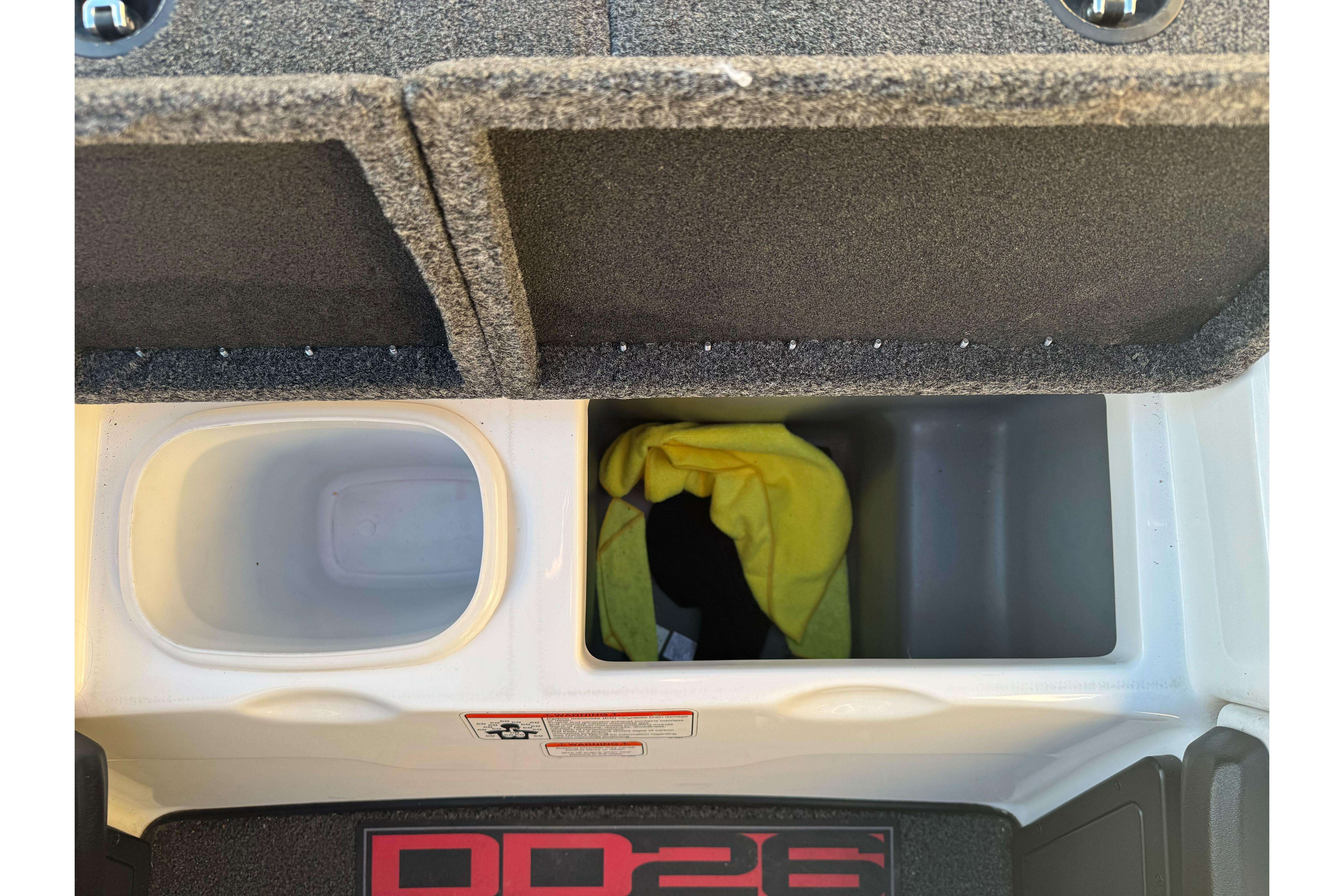 2011 Nitro Z-9 DC boat storage compartments with yellow cloth and carpeted lids.