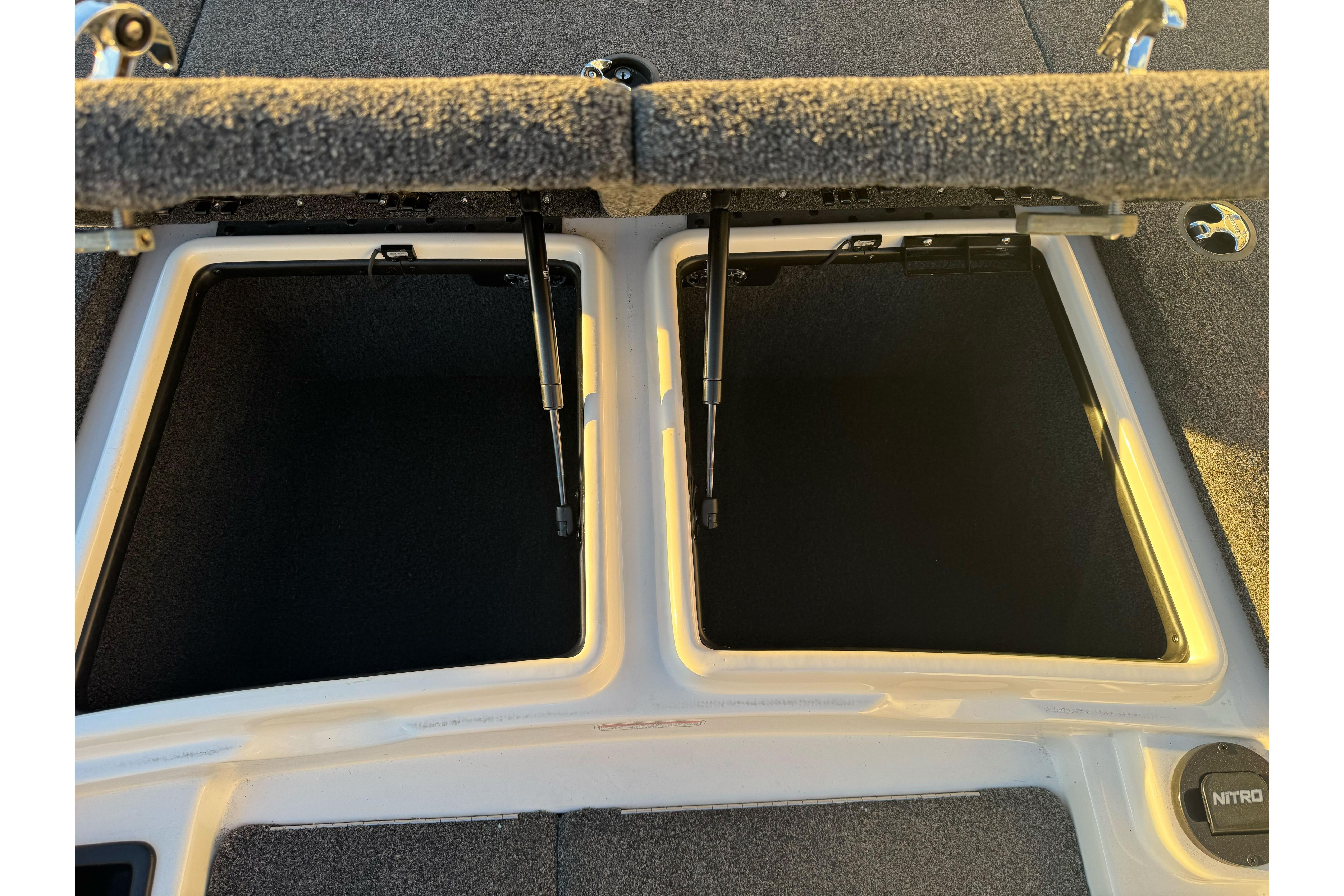 2011 Nitro Z-9 DC boat storage compartments with open lids.