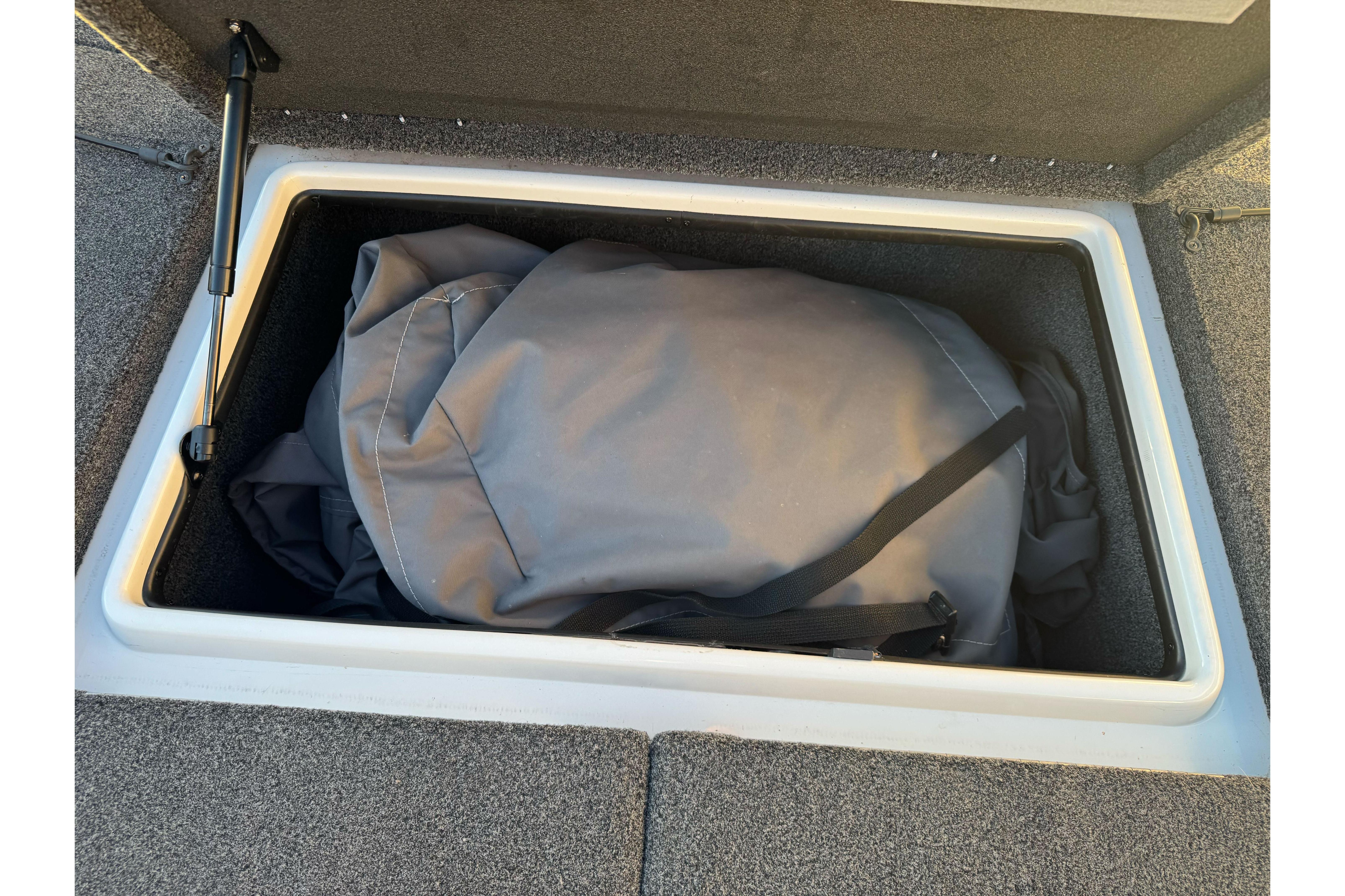 Storage compartment in a 2011 Nitro Z-9 DC boat with a gray bag inside.