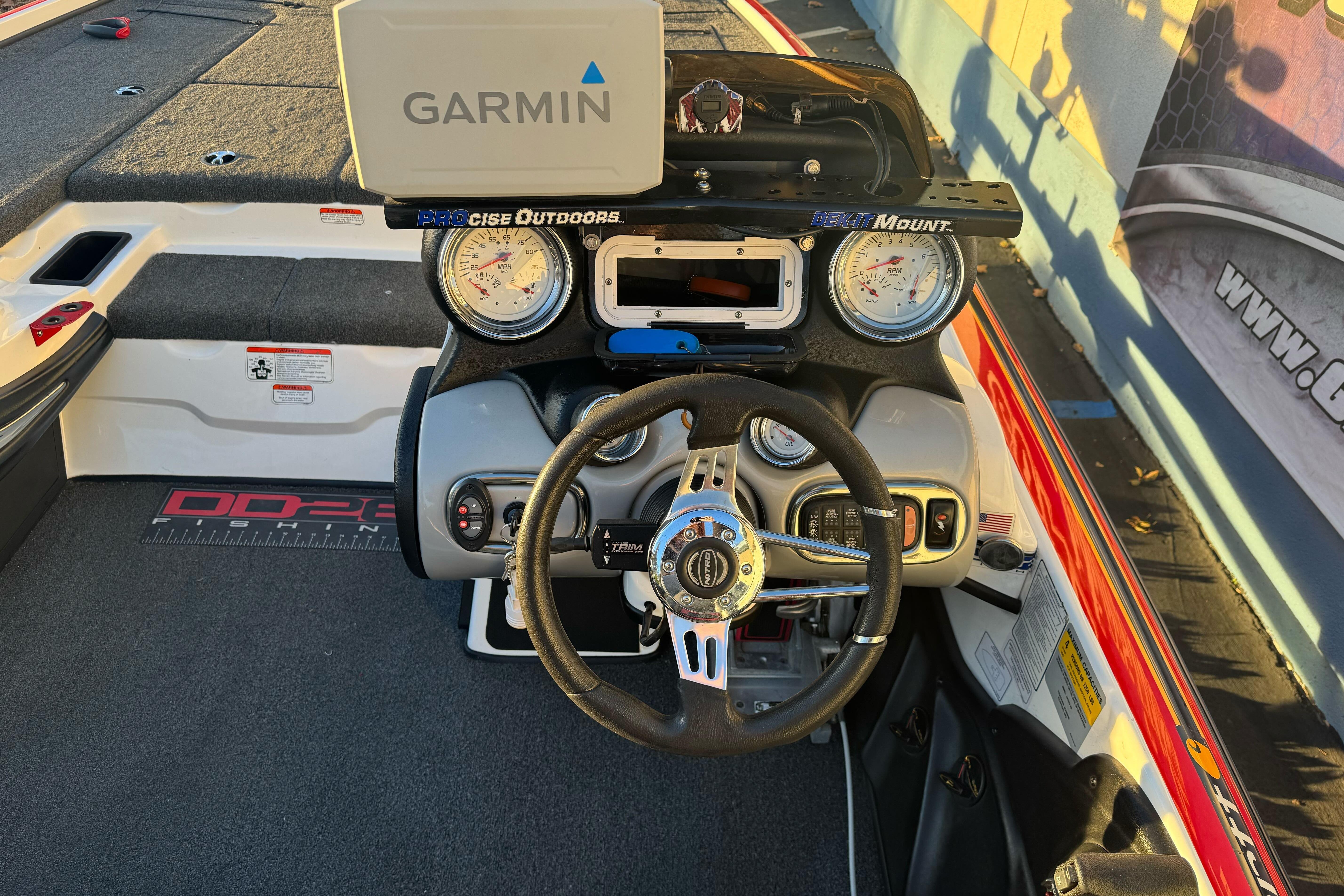 2011 Nitro Z-9 DC boat dashboard with Garmin GPS and steering wheel.