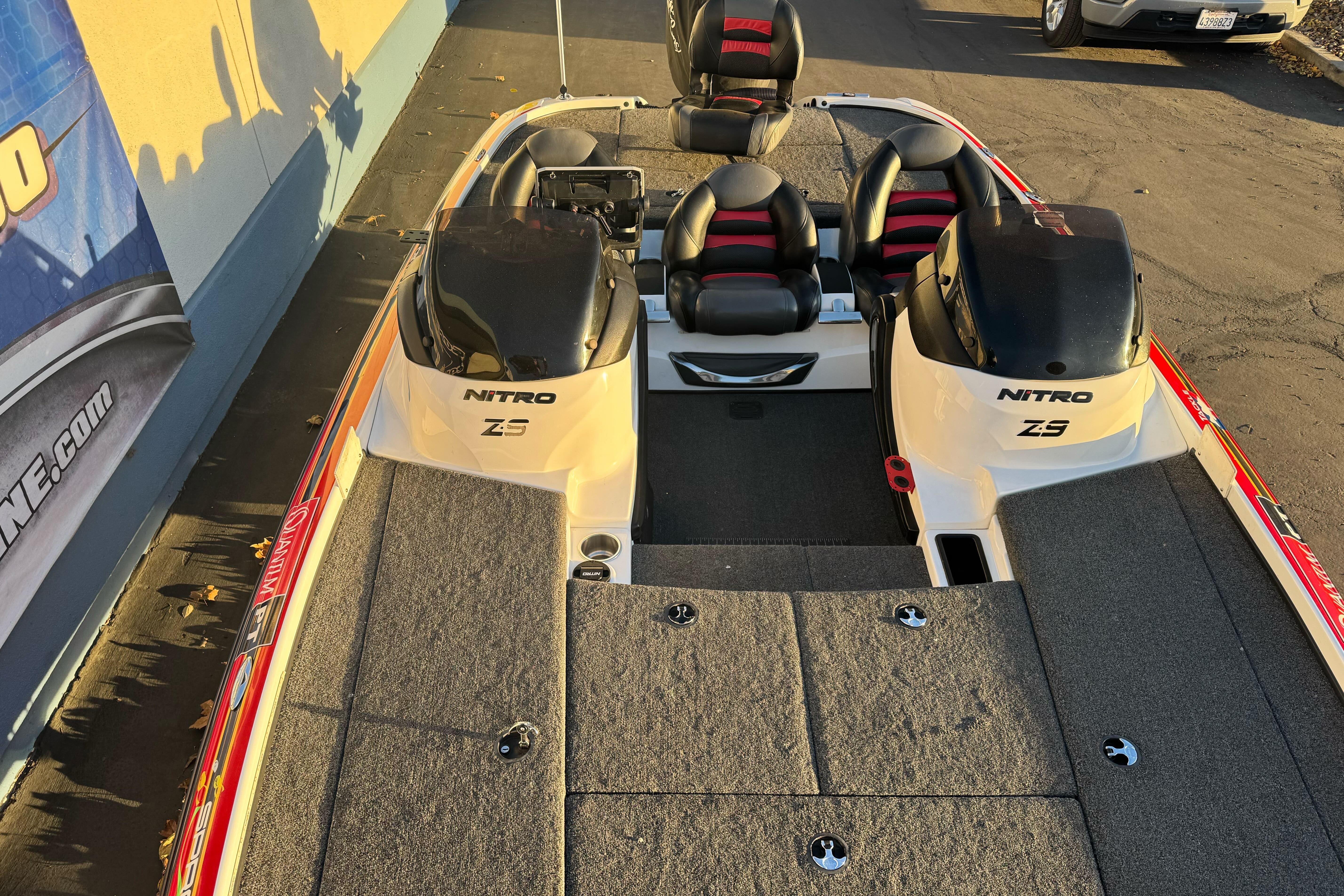 2011 Nitro Z-9 DC boat with dual engines and seating, parked outdoors.