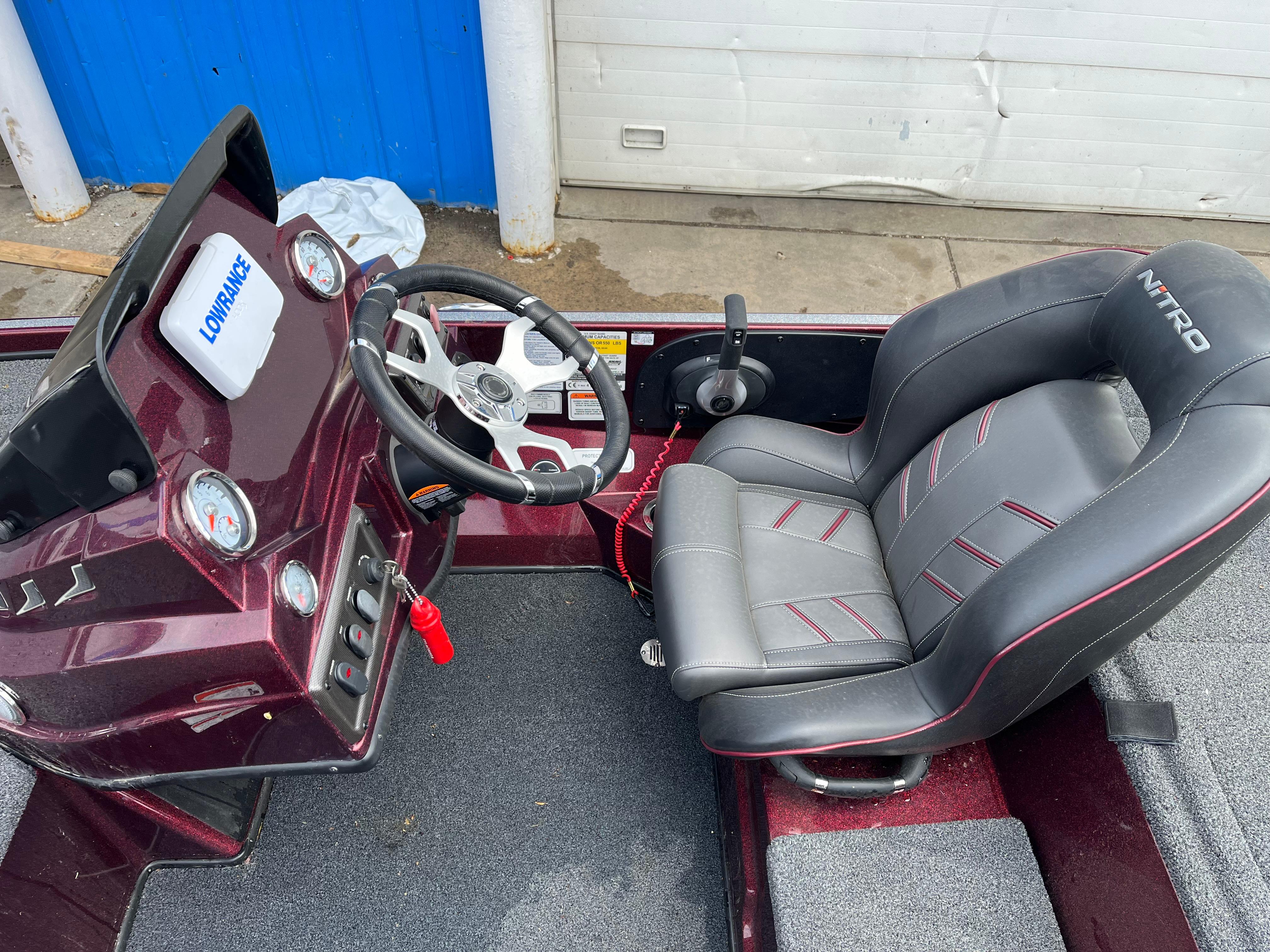 Nitro Z18 2022 boat cockpit with steering wheel and seat, featuring Lowrance electronics.