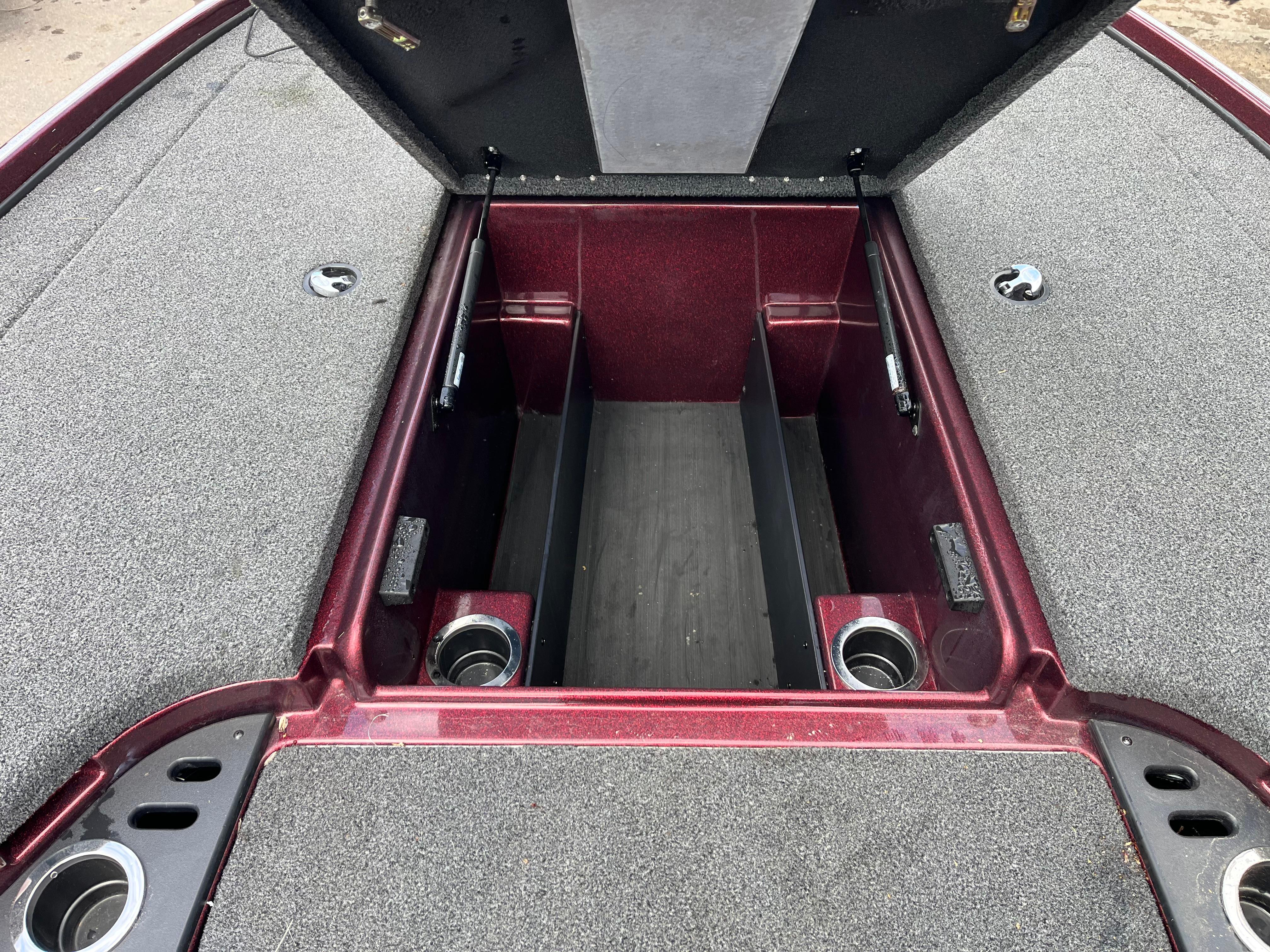 2022 Nitro Z18 boat storage compartment with open lid, showcasing spacious interior and cup holders.