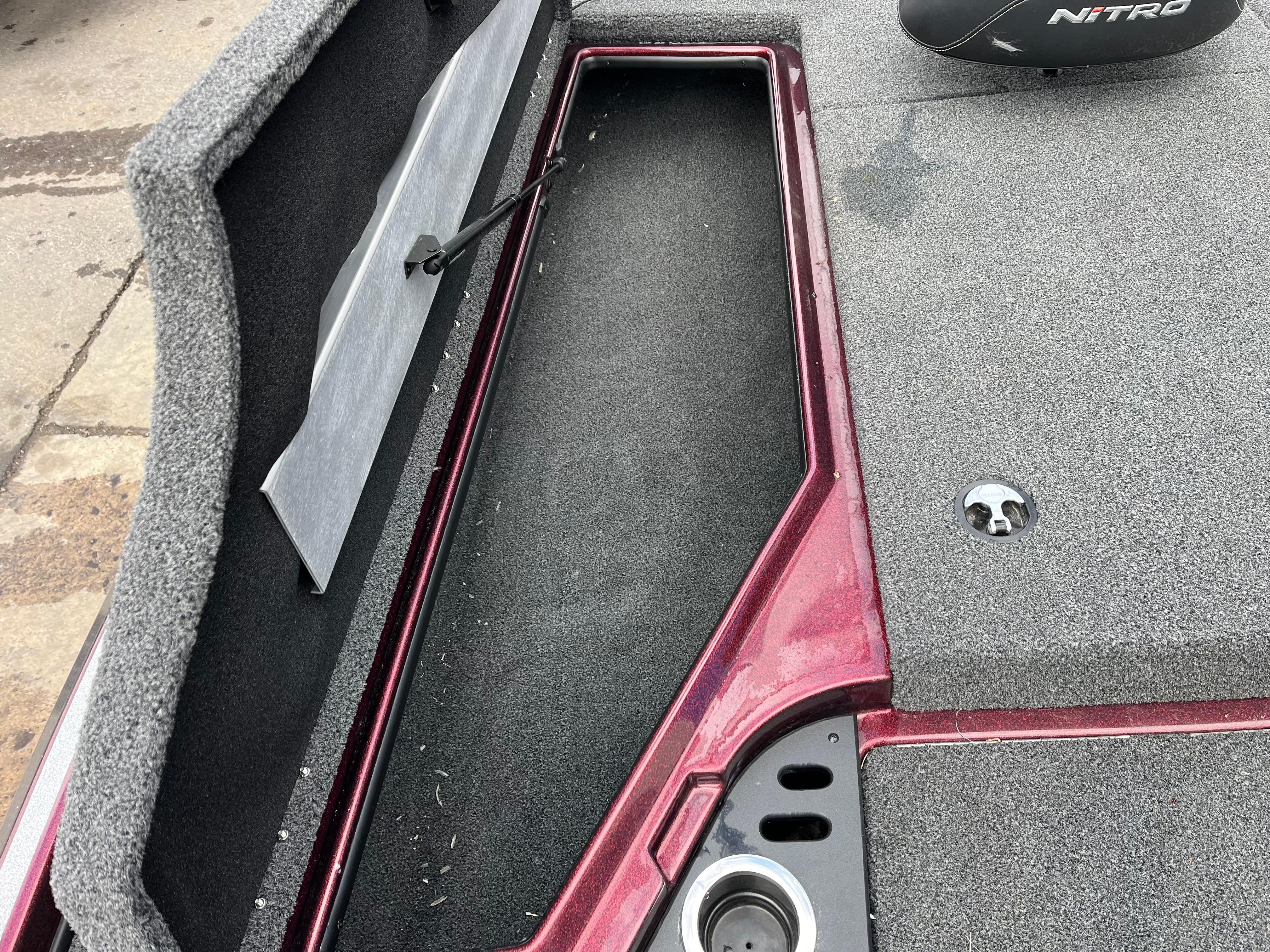 2022 Nitro Z18 boat interior with storage compartment and carpeted deck.