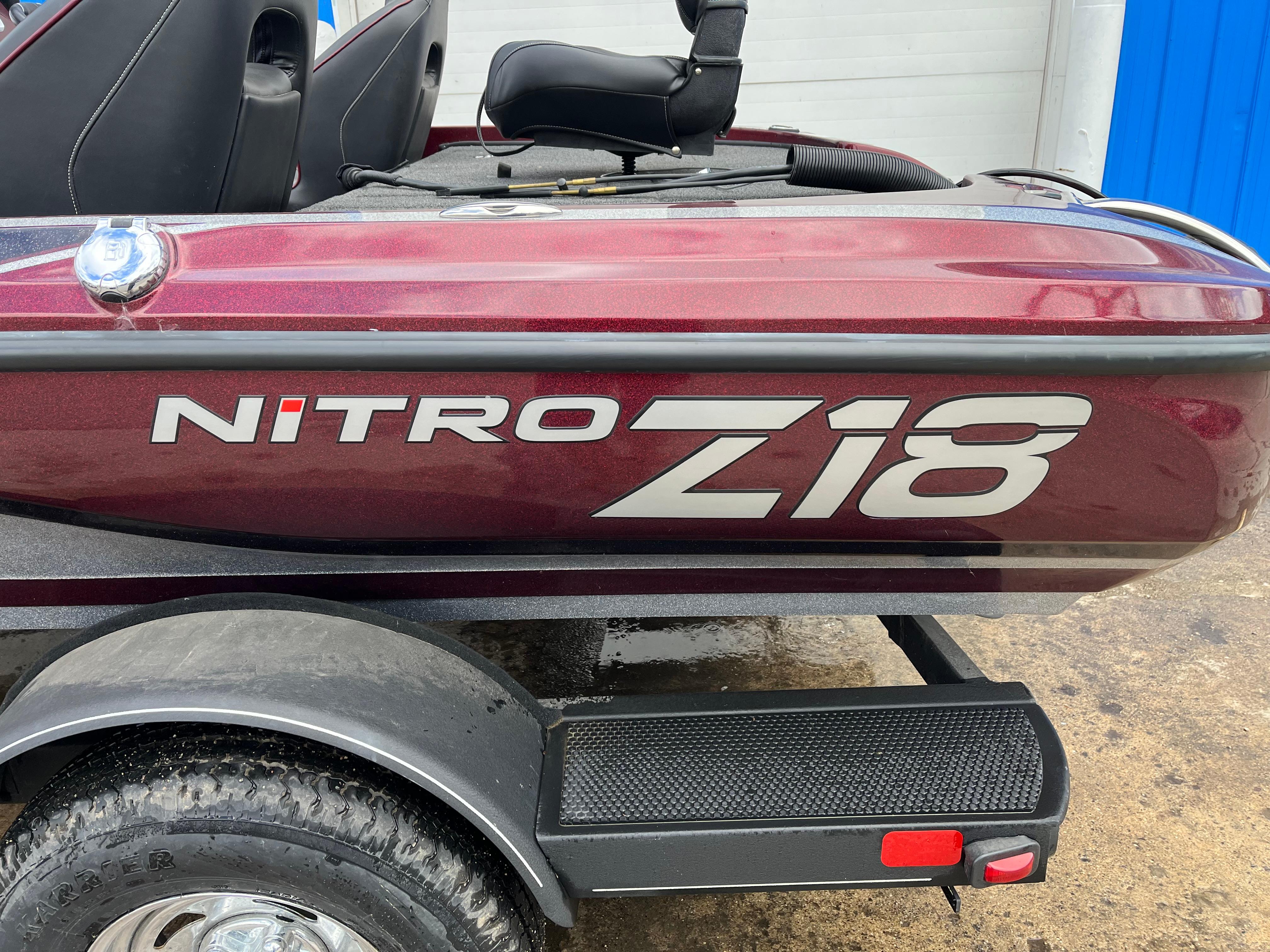 2022 Nitro Z18 boat with maroon finish and sleek design on a trailer.