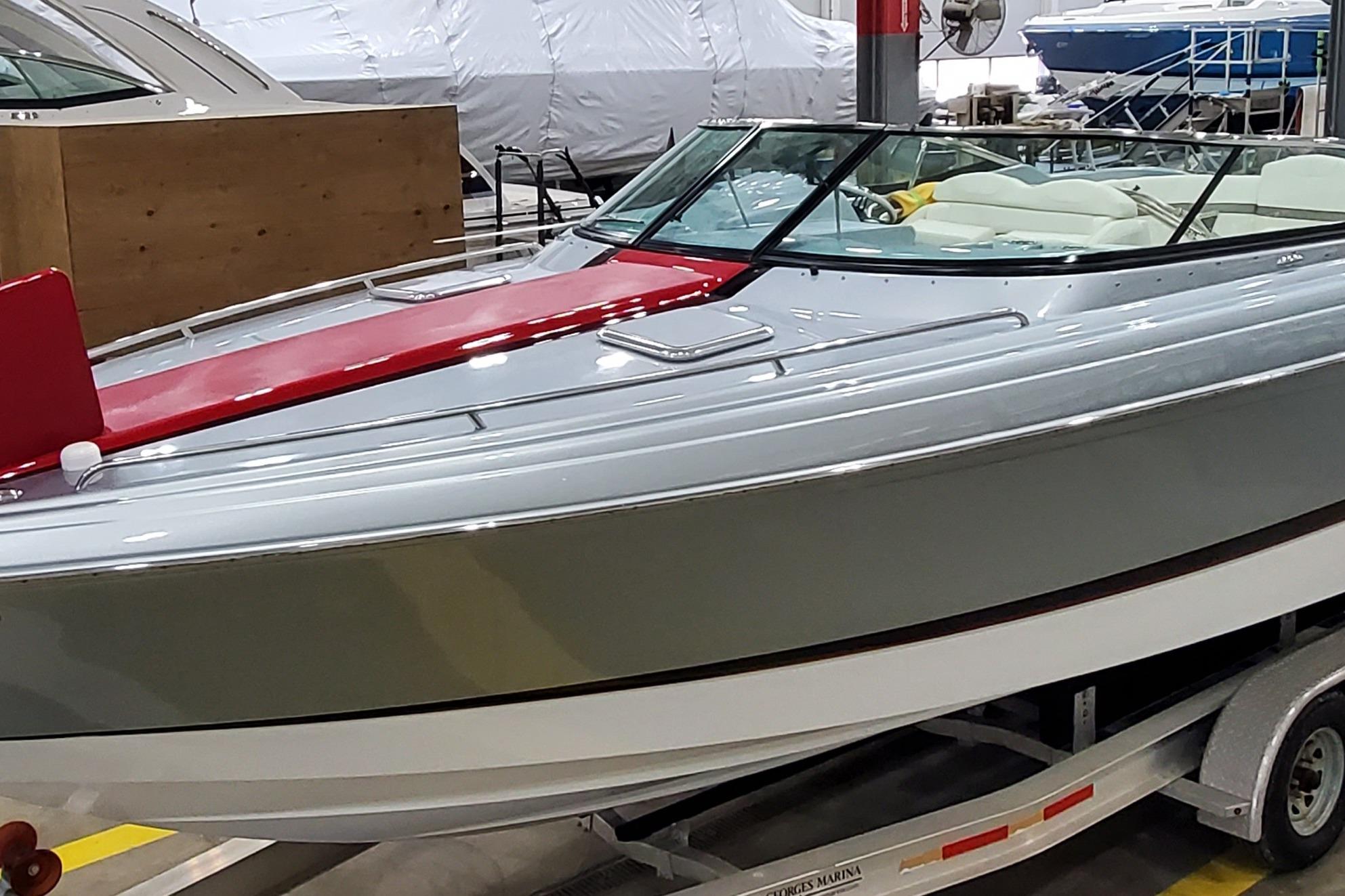 2011 Formula 310 FX5 Bowrider boat on trailer in showroom.