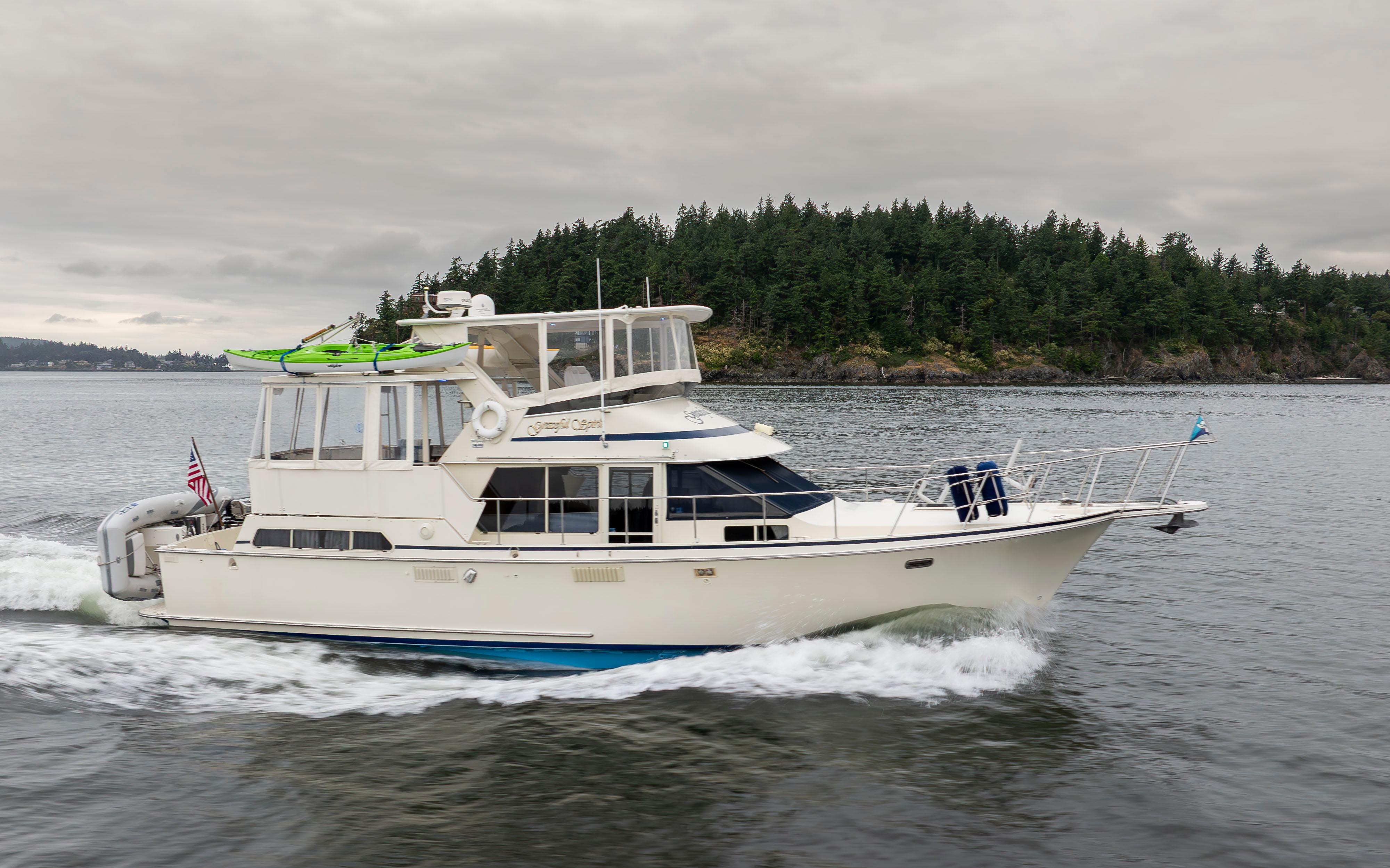 Tollycraft-44 Cockpit Motor Yacht 1990-Graceful Spirit WA-US-1990 Tollycraft 44 Cockpit Motor Yacht cruising near forested shoreline.-9844071