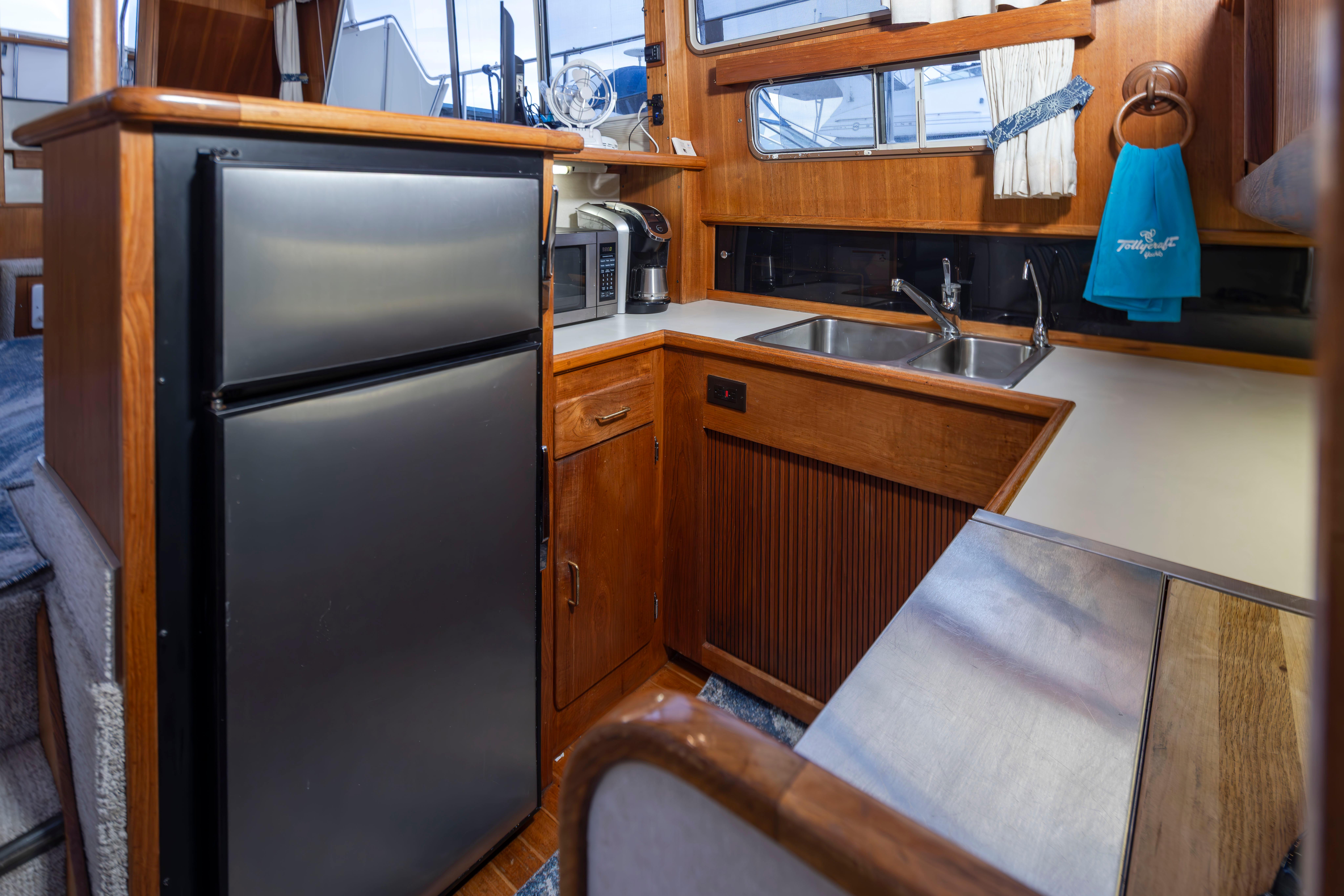 Tollycraft-44 Cockpit Motor Yacht 1990-Graceful Spirit WA-US-1990 Tollycraft 44 Cockpit Motor Yacht kitchen with stainless steel appliances and wooden cabinetry.-9844071 | Thumbnail