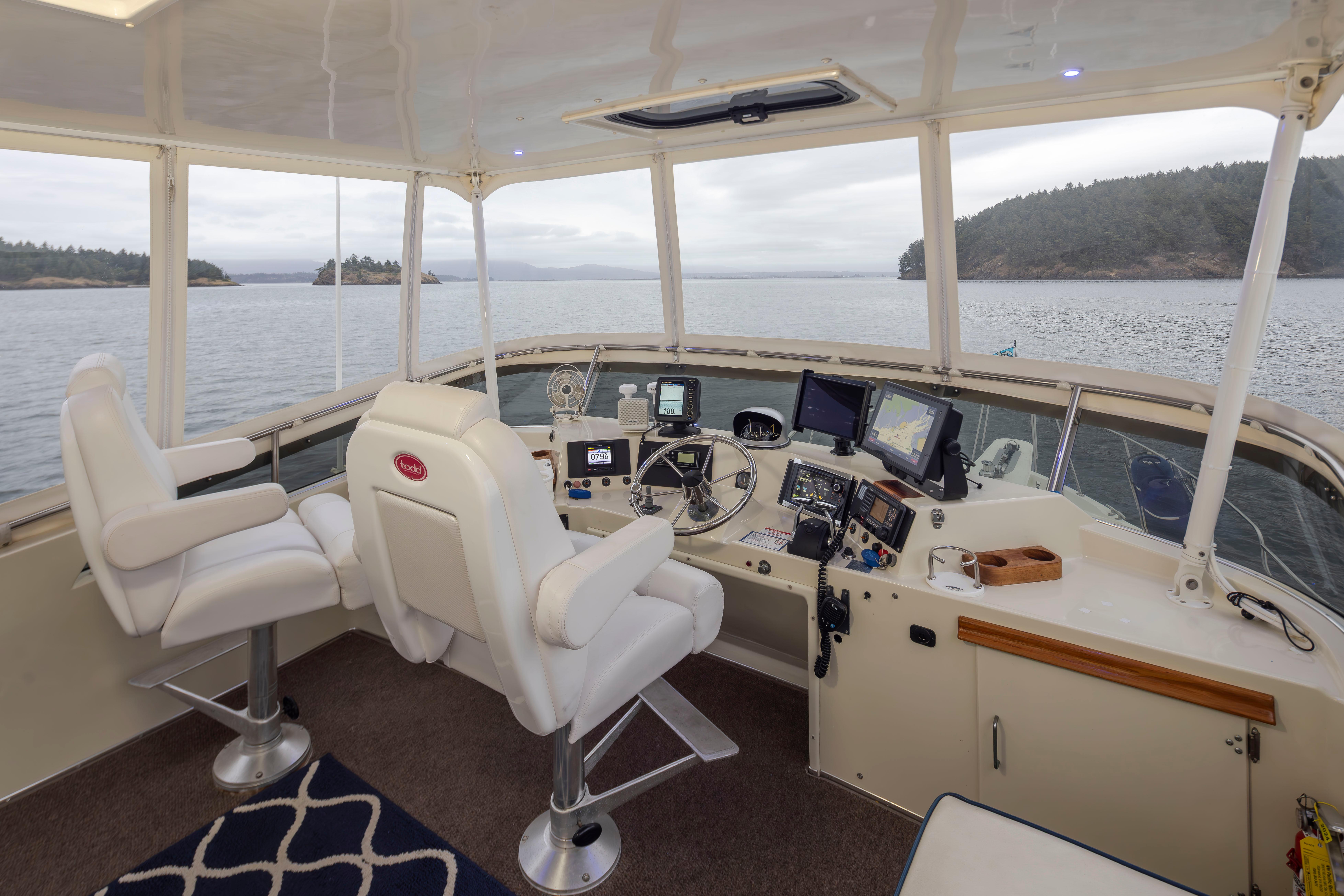 Tollycraft-44 Cockpit Motor Yacht 1990-Graceful Spirit WA-US-Interior of 1990 Tollycraft 44 Cockpit Motor Yacht with navigation equipment and scenic water view.-9844071 | Thumbnail
