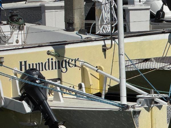 1982 Greene Marine 35 Acapella boat named "Humdinger" docked with visible outboard motor.