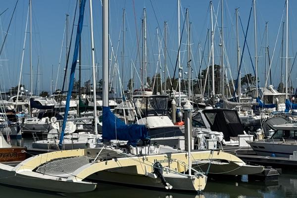 Marina with various sailboats, featuring a 1982 Greene Marine 35 Acapella trimaran.