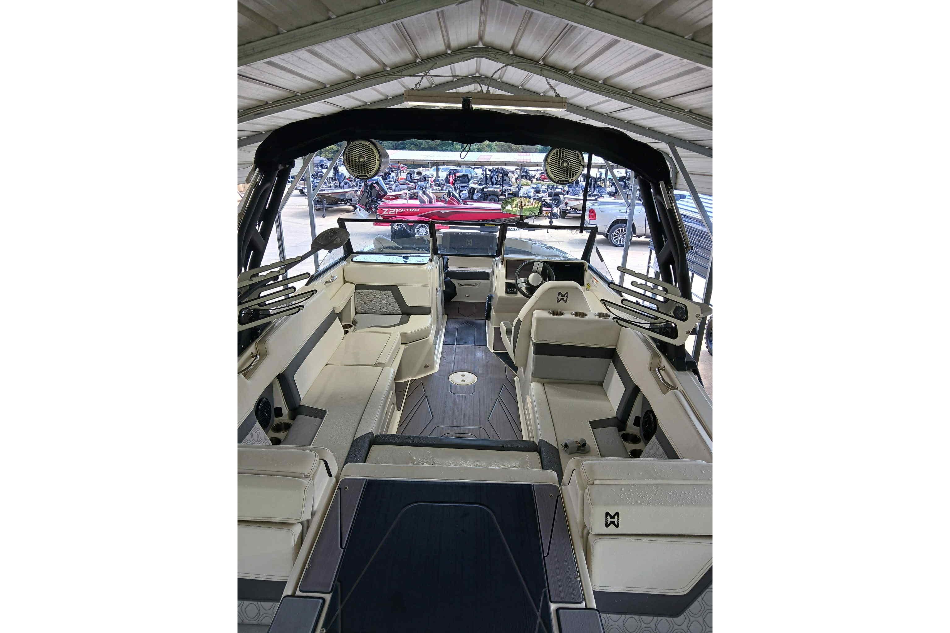 2023 Heyday H22 boat interior with spacious seating and modern design under a canopy.
