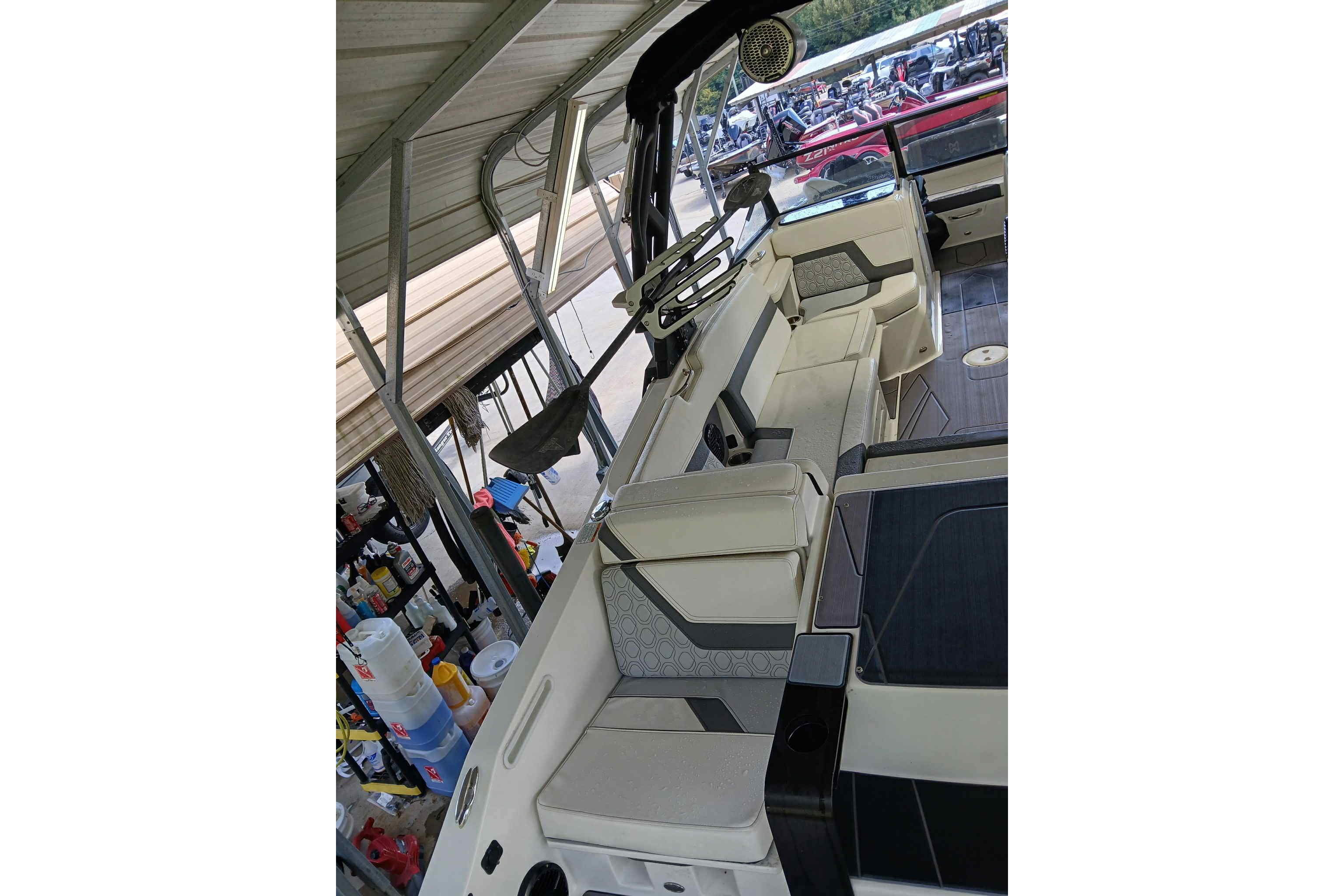 2023 Heyday H22 boat interior with modern seating and steering wheel under a canopy.