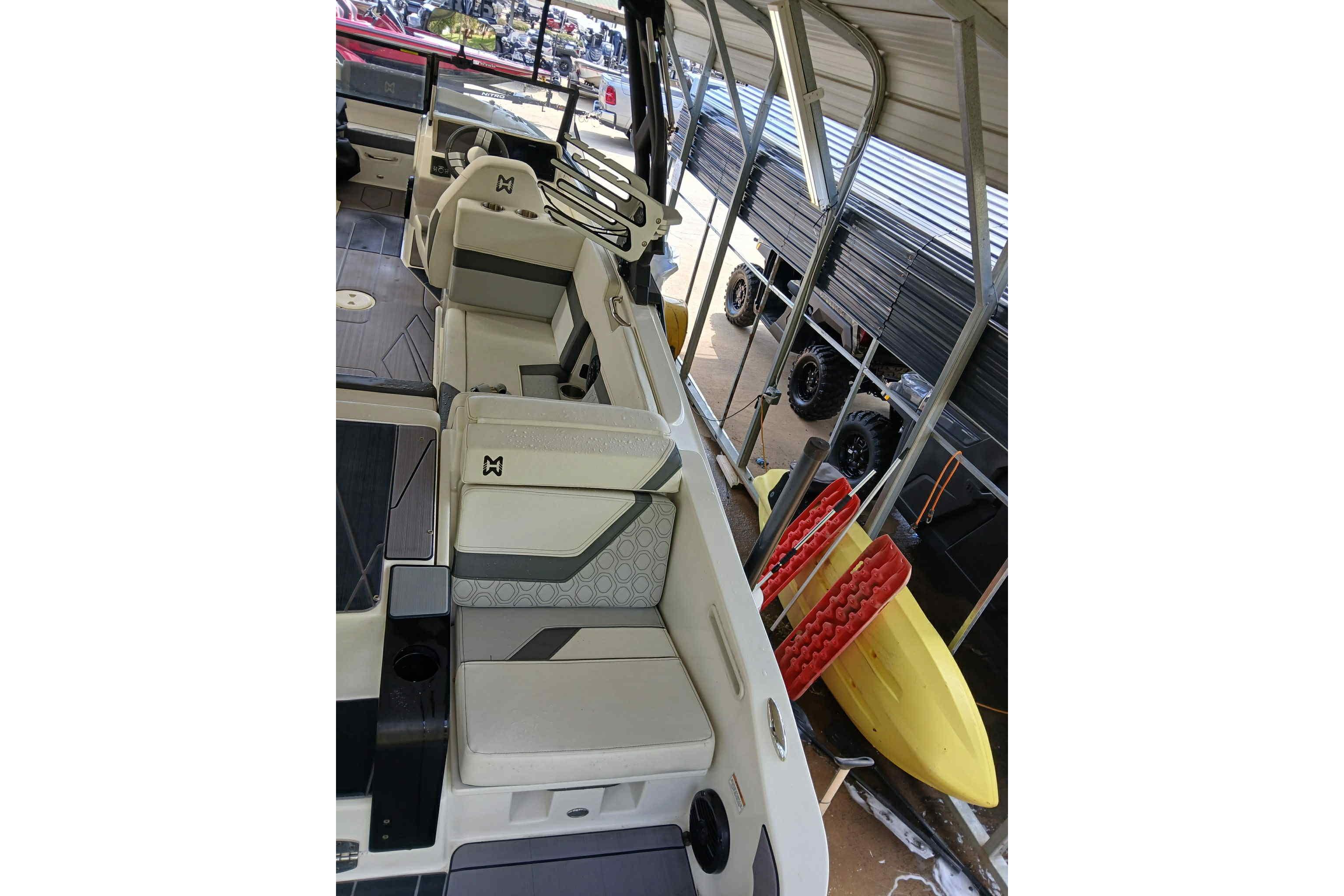 2023 Heyday H22 boat interior with modern seating and storage, under a covered dock.