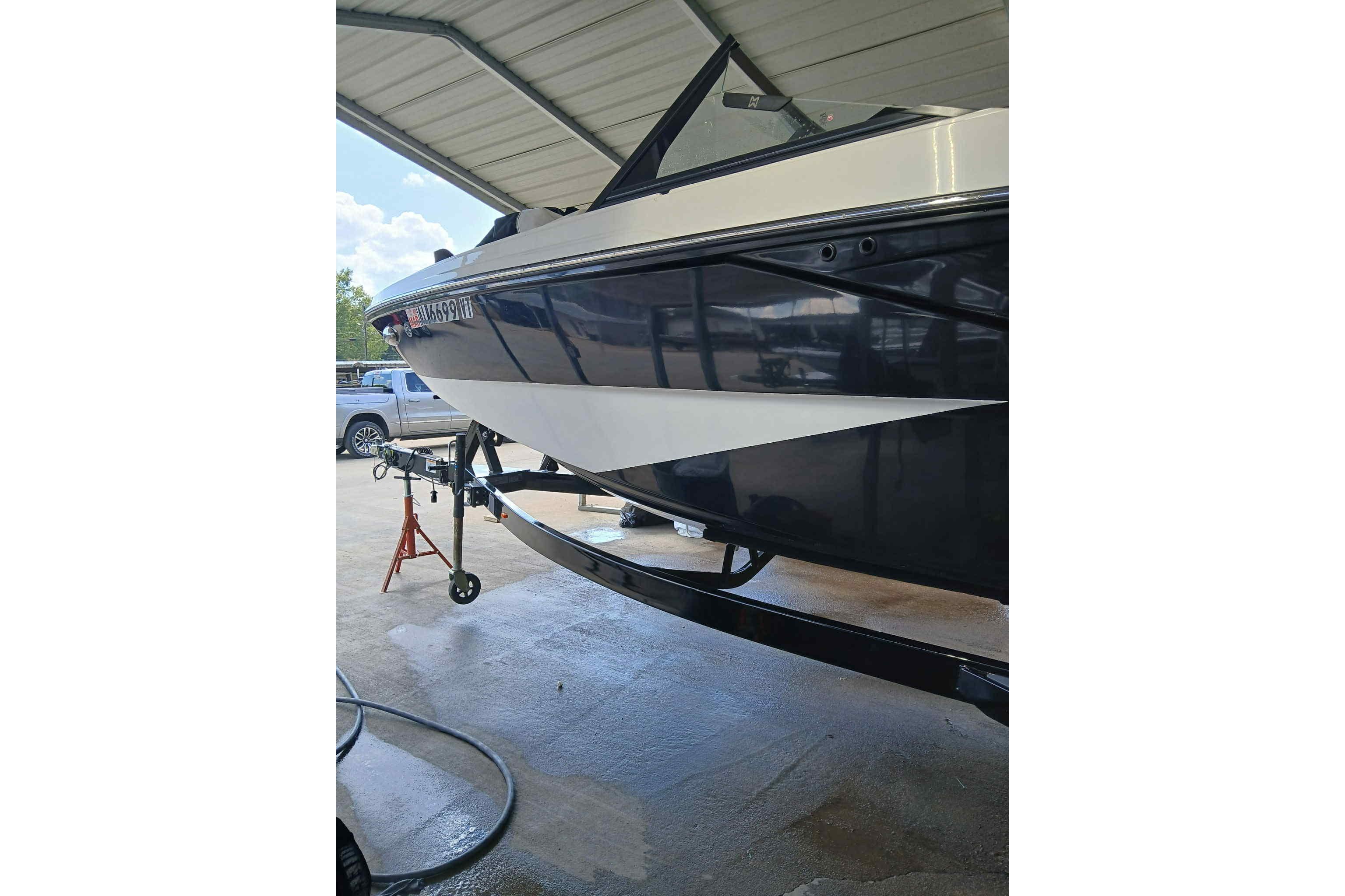 2023 Heyday H22 boat under a covered area, side view.