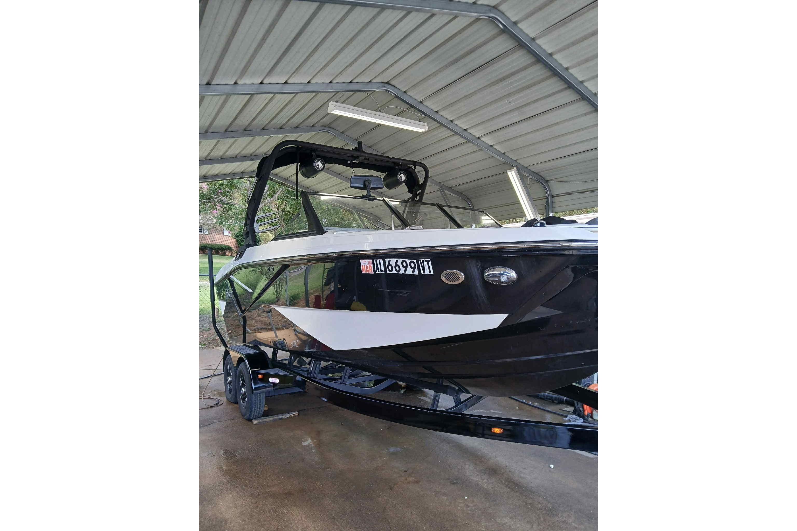 2023 Heyday H22 boat under a metal canopy, black and white design.