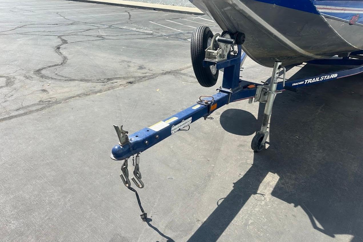 2005 Bass Tracker Pro Team 175 boat trailer hitch on asphalt parking lot.